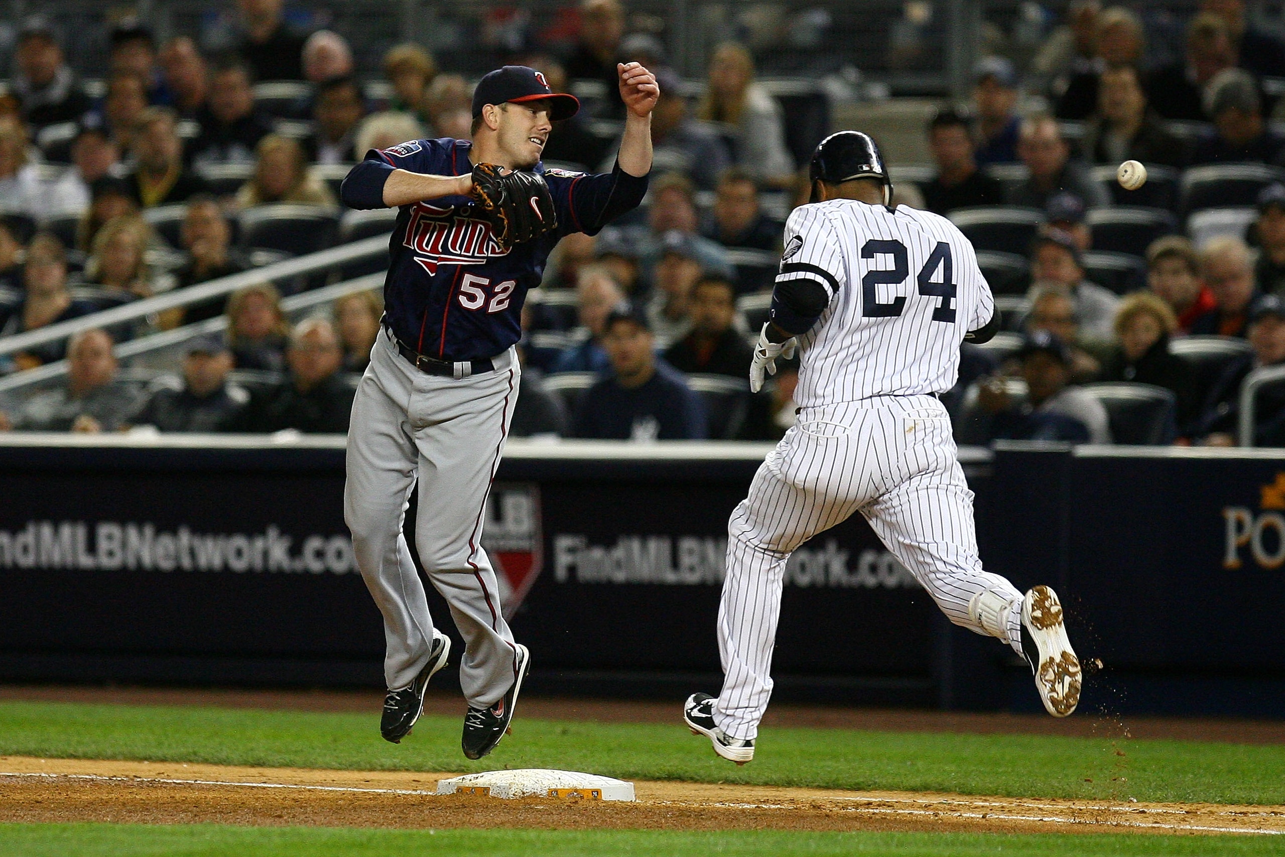 NEW YORK - OCTOBER 09:  Robinson Cano #24 of the New York Yankees reaches first base on an infield single in the bottom of the fourth inning against Brian Duensing #52 of the Minnesota Twins during Game Three of the ALDS part of the 2010 MLB Playoffs at Y