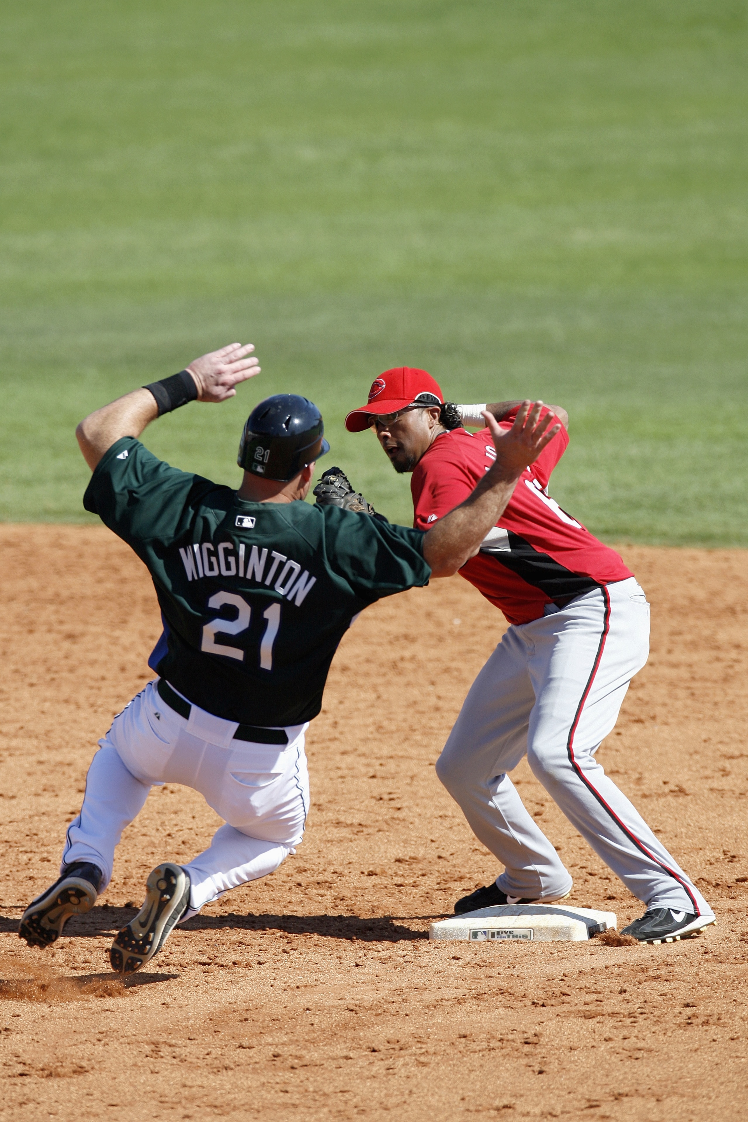 ST. PETERSBURG, FL - MARCH 6: Anderson Machado #68 of the Cincinnati Reds tags out Ty Wigginton#21 of the Tampa Bay Devil Rays on March 6, 2007 at Progress Energy Park, Home of Al Lang Field in St. Petersburg, Florida. Cincinnati won the game 3-1. (Photo