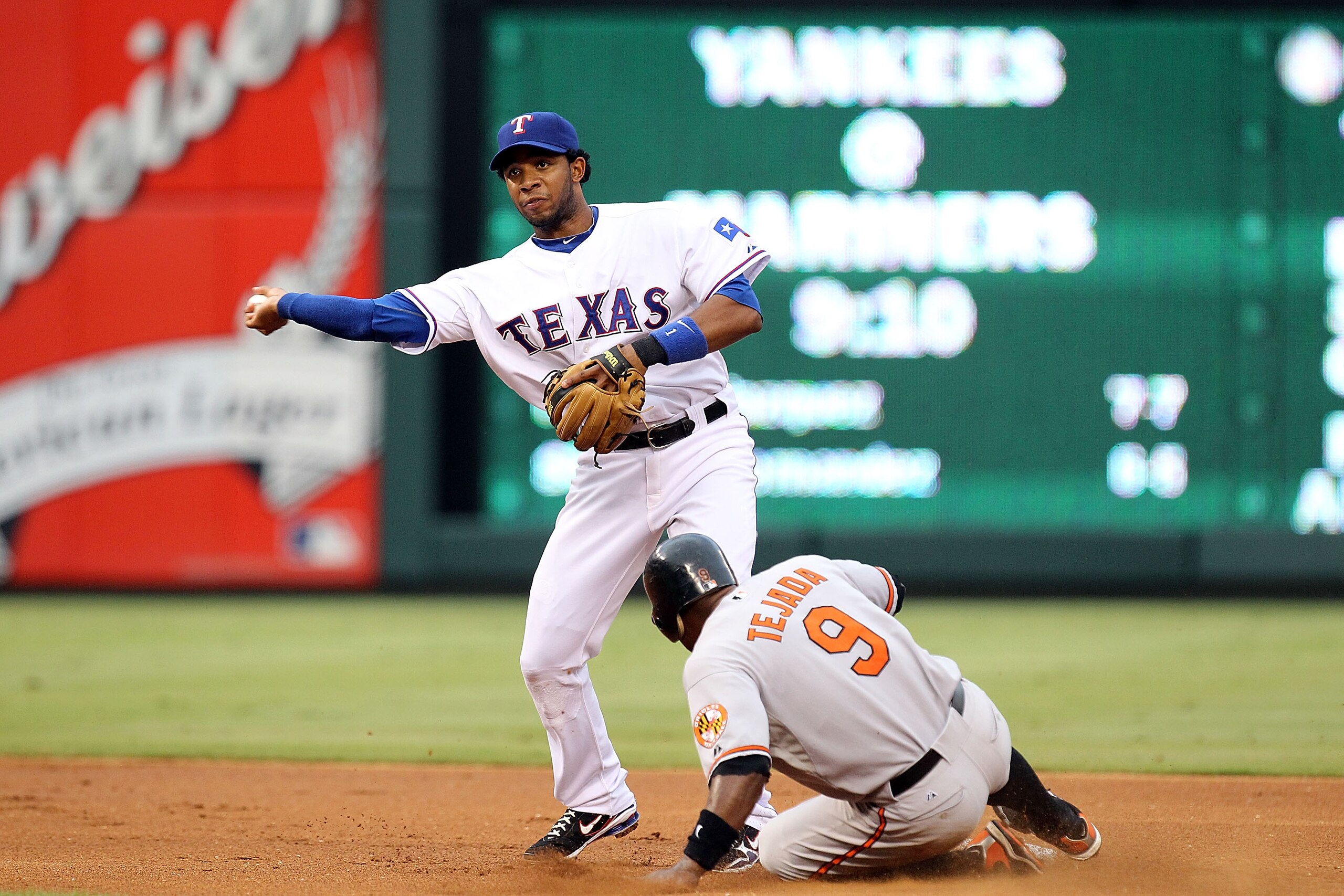 ARLINGTON, TX - JULY 10:  Shortstop Elvis Andrus #1 of the Texas Rangers makes the out at second against Miguel Tejada #9 of the Baltimore Orioles on July 10, 2010 at Rangers Ballpark in Arlington, Texas.  (Photo by Ronald Martinez/Getty Images)
