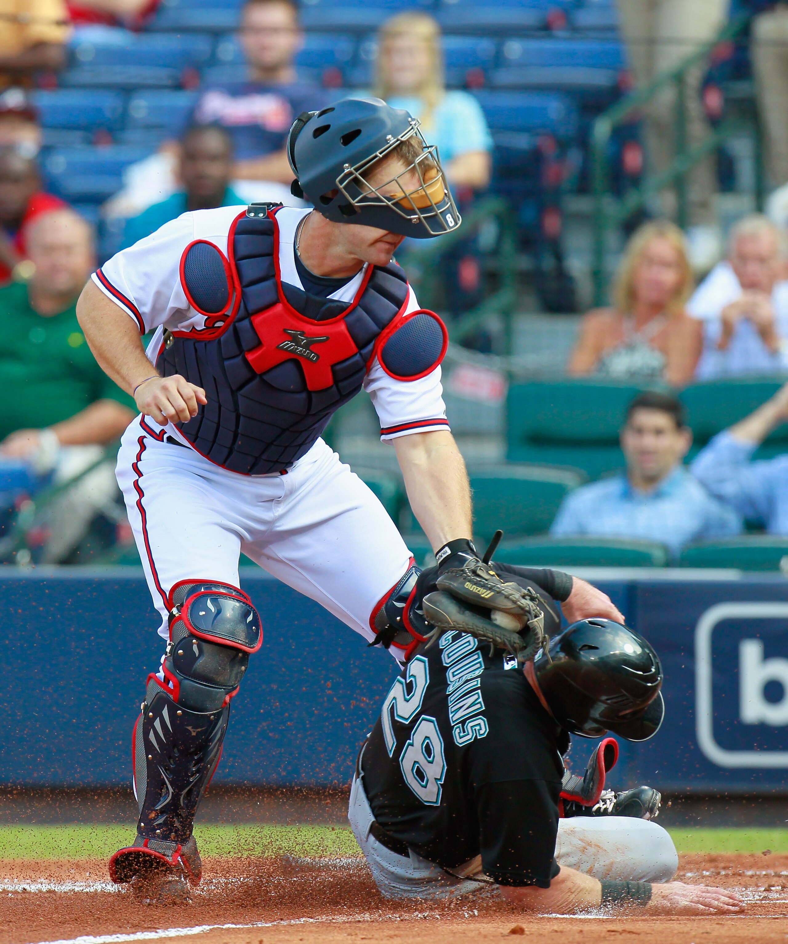 ATLANTA - SEPTEMBER 29:  Catcher David Ross #8 of the Atlanta Braves tags out Scott Cousins #28 of the Florida Marlins at homeplate at Turner Field on September 29, 2010 in Atlanta, Georgia.  (Photo by Kevin C. Cox/Getty Images)