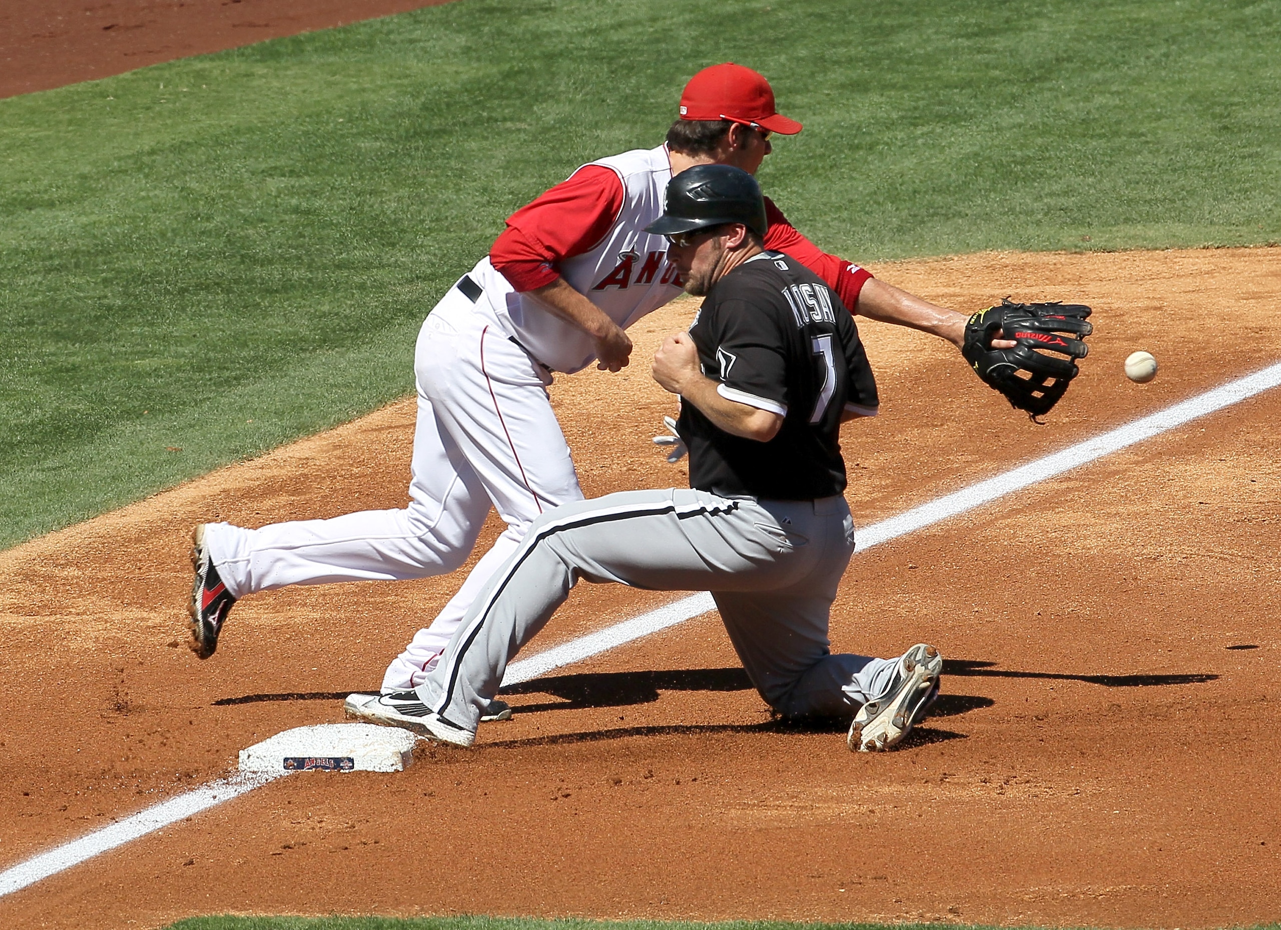 ANAHEIM, CA - SEPTEMBER 26:  Mark Kotsay #7 of the Chicago White Sox slides into third ahead of the throw to third baseman Brandon Wood #3 of the Los Angeles Angels of Anaheim in the second inning on September 26, 2010 at Angel Stadium in Anaheim, Califor