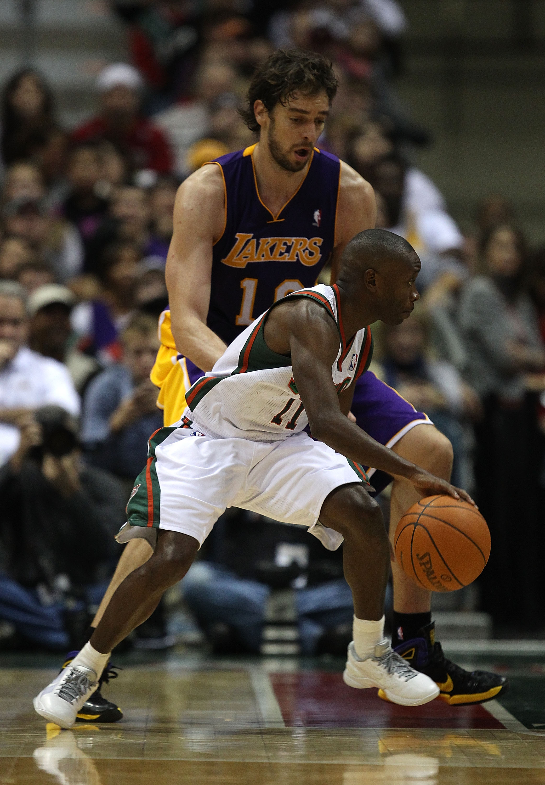 MILWAUKEE - NOVEMBER 16: Earl Boykins #11 of the Milwaukee Bucks dribbles around Pau Gasol #16 of the Los Angeles Lakers at the Bradley Center on November 16, 2010 in Milwaukee, Wisconsin. The Lakers defeated the Bucks 118-107. NOTE TO USER: User expressl