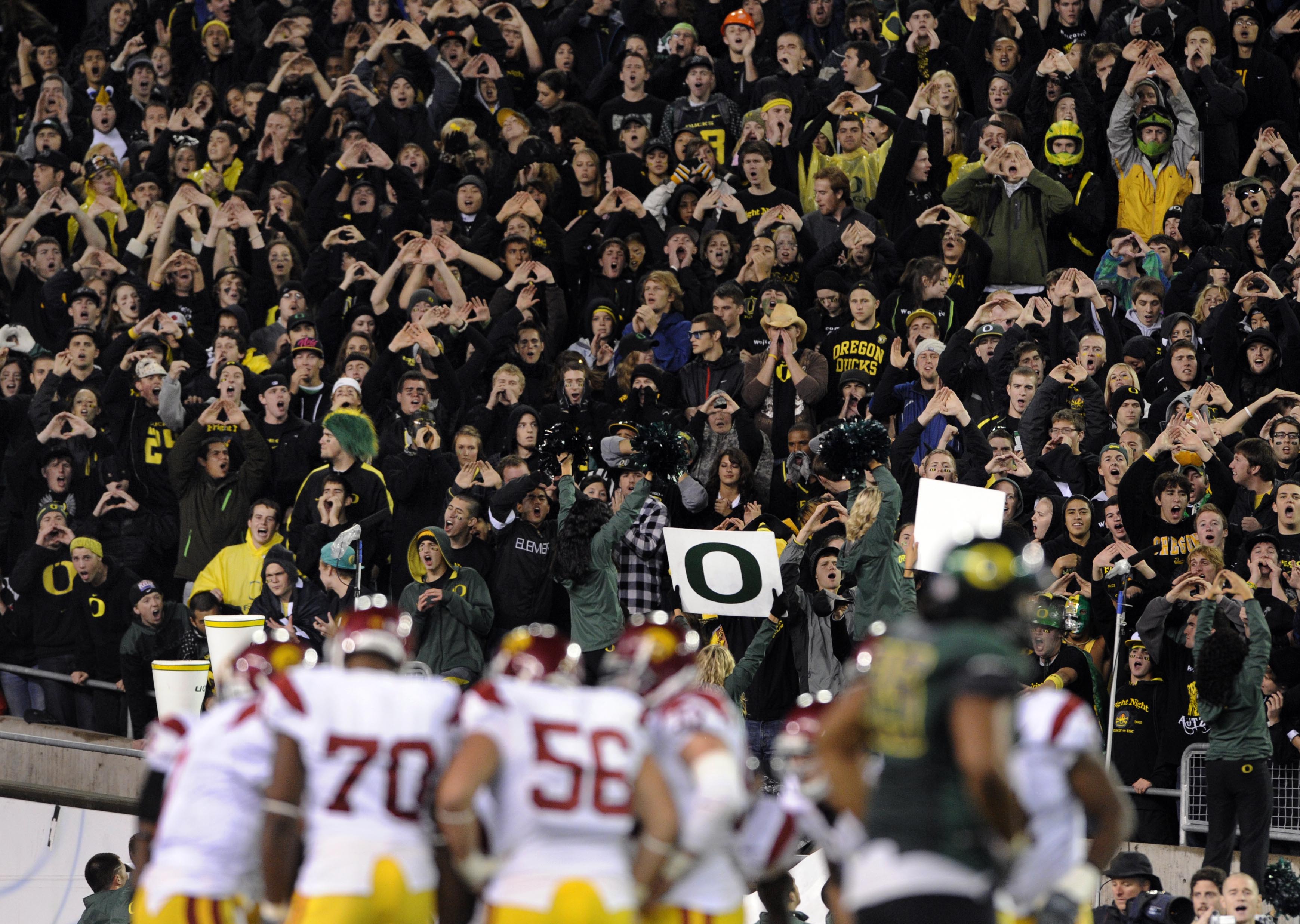 EUGENE, OR - OCTOBER 31: Oregon Duck fans stand up and cheer as the USC Trojans huddle in the third quarter of the game at Autzen Stadium on October 31, 2009 in Eugene, Oregon. The Ducks upset the Trojans 47-20. (Photo by Steve Dykes/Getty Images)