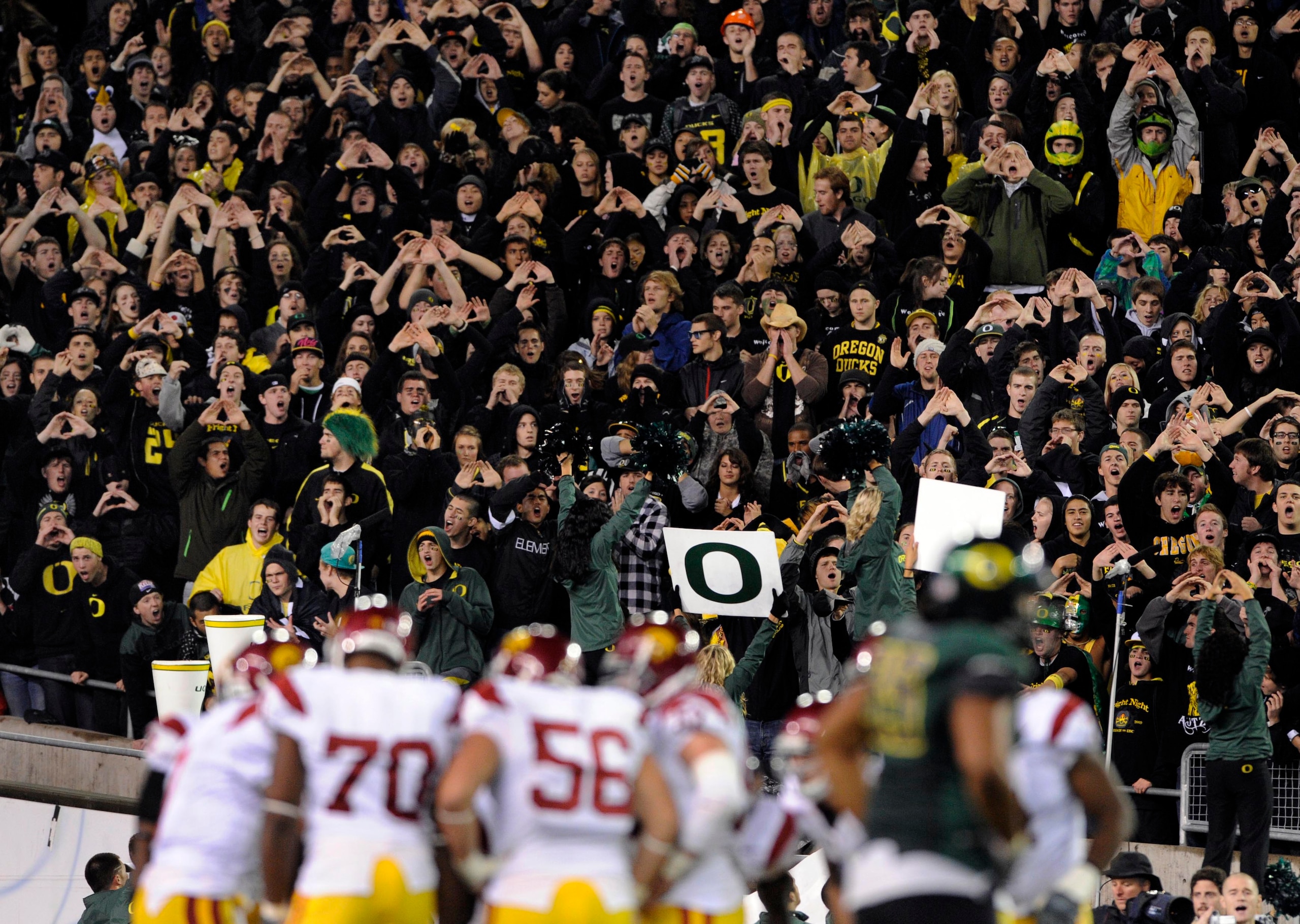 EUGENE, OR - OCTOBER 31: Oregon Duck fans stand up and cheer as the USC Trojans huddle in the third quarter of the game at Autzen Stadium on October 31, 2009 in Eugene, Oregon. The Ducks upset the Trojans 47-20. (Photo by Steve Dykes/Getty Images) EUGENE, OR - OCTOBER 31: Oregon Duck fans stand up and cheer as the USC Trojans huddle in the third quarter of the game at Autzen Stadium on October 31, 2009 in Eugene, Oregon. The Ducks upset the Trojans 47-20. (Photo by Steve Dykes/Getty Images)