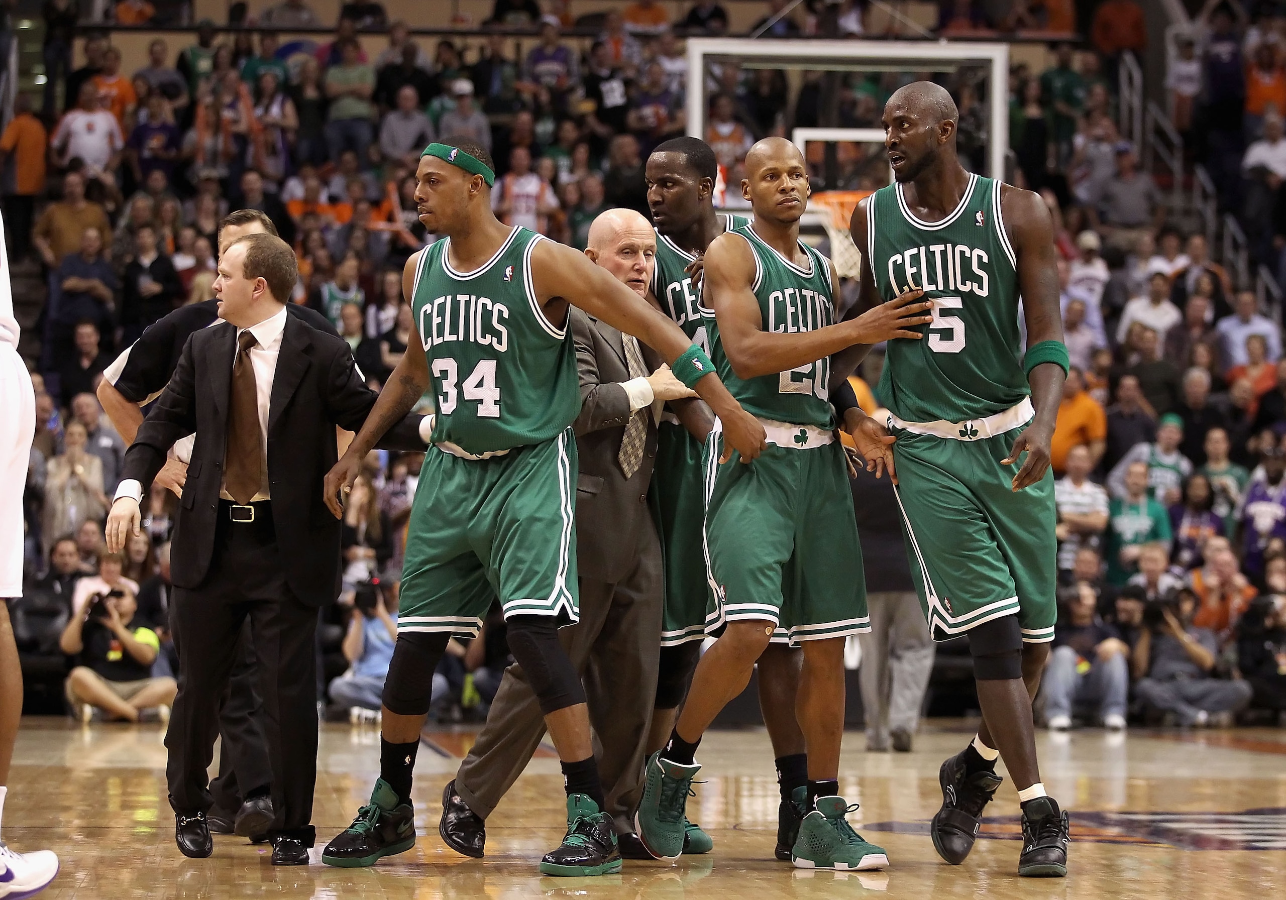 PHOENIX, AZ - JANUARY 28:  Assistant coach Lawrence Frank of the Boston Celtics walks Paul Pierce #34, Ray Allen #20 and Kevin Garnett #5 back to the bench after an altercation against the Phoenix Suns during the NBA game at US Airways Center on January 2