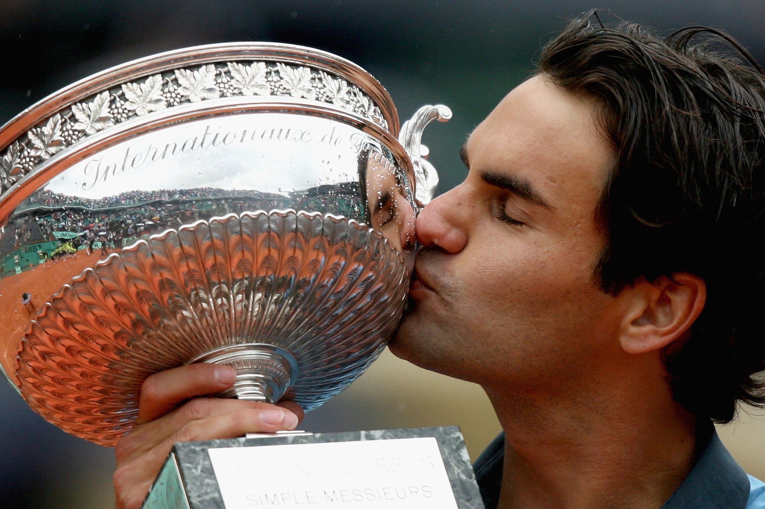 PARIS - JUNE 07:  Roger Federer of Switzerland kisses the trophy as he celebrates victory during the Men's Singles Final match against Robin Soderling of Sweden on day fifteen of the French Open at Roland Garros on June 7, 2009 in Paris, France.  (Photo b