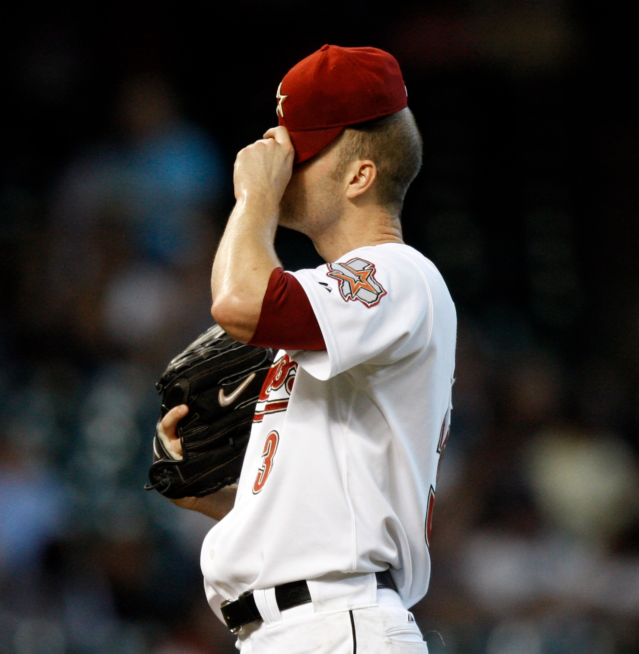 HOUSTON - SEPTEMBER 15:  Pitcher J.A. Happ #30 of the Houston Astros wipes his face after allowing three runs  against the Milwaukee Brewers in the first inning at Minute Maid Park on September 15, 2010 in Houston, Texas.  (Photo by Bob Levey/Getty Images
