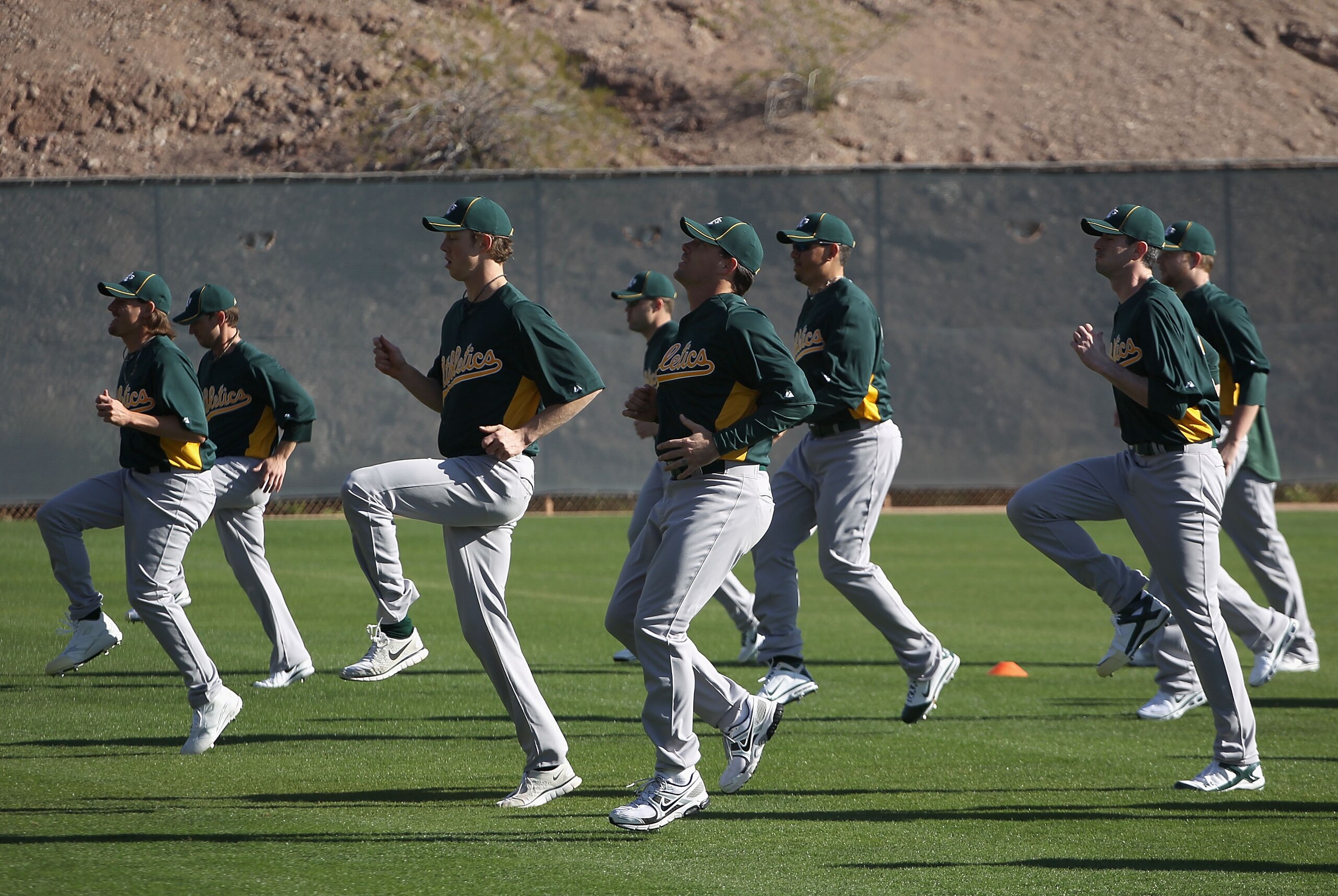 PHOENIX, AZ - FEBRUARY 16:  Pitchers for the Oakland Athletics warm up during a MLB spring training practice at Phoenix Municipal Stadium on February 16, 2011 in Phoenix, Arizona.  (Photo by Christian Petersen/Getty Images)