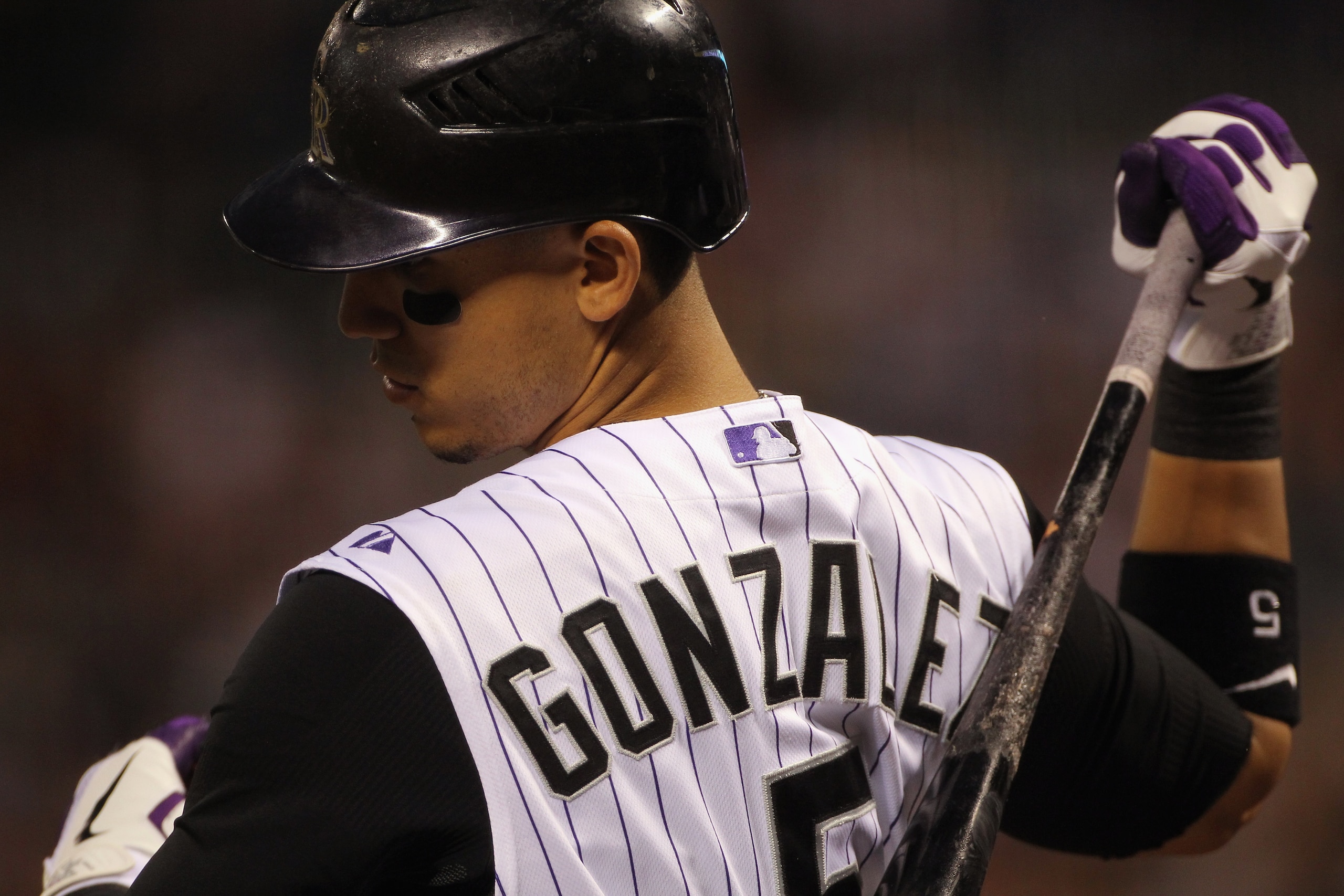 DENVER - SEPTEMBER 27:  Carlos Gonzalez #5 of the Colorado Rockies warms up on deck as he prepares to take an at bat against the Los Angeles Dodgers at Coors Field on September 25, 2010 in Denver, Colorado. The Dodgers defeated the Rockies 3-1.  (Photo by