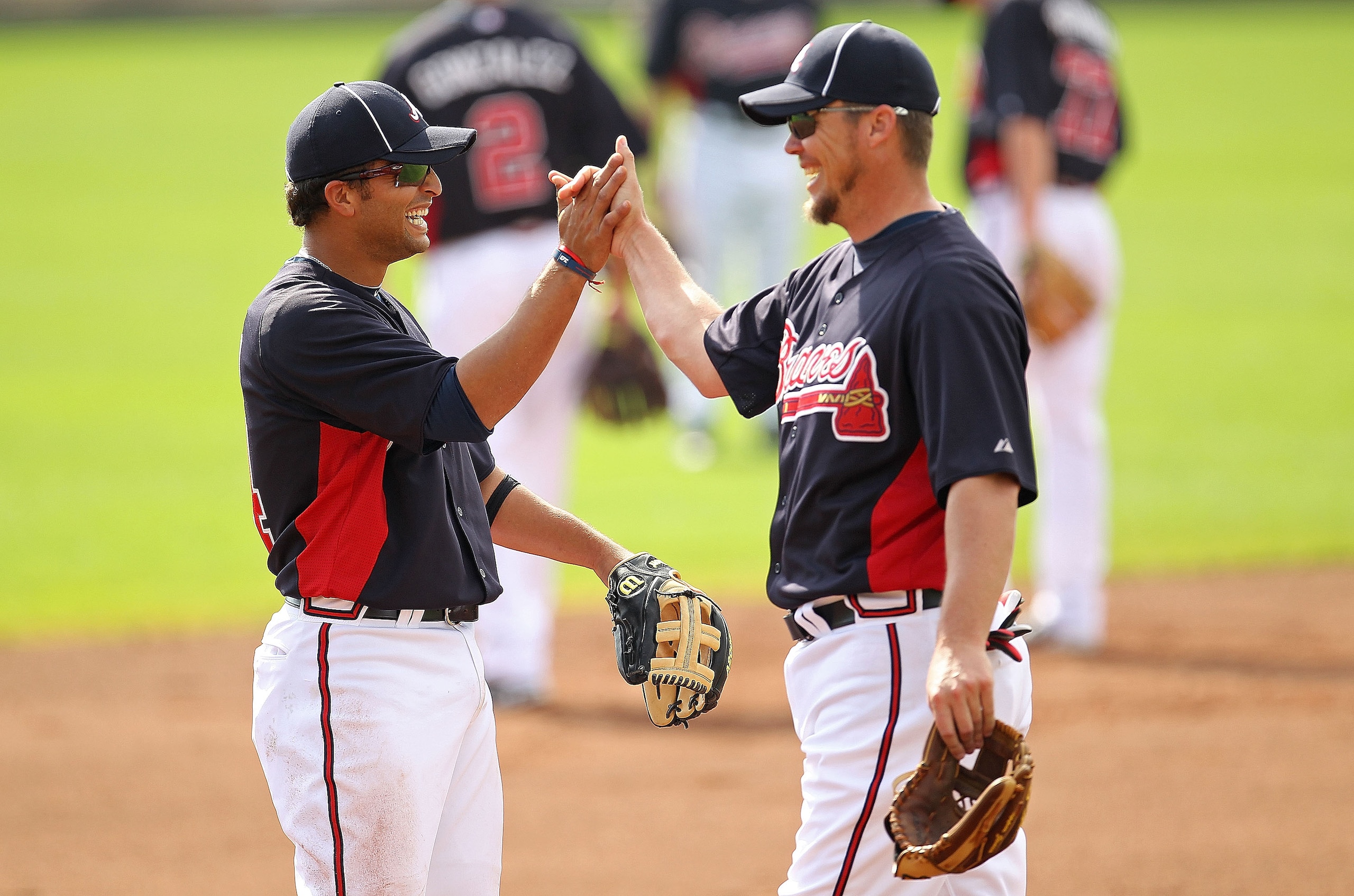 LAKE BUENA VISTA, FL - FEBRUARY 21:  Martin Prado #14 and Chipper Jones #10 of the Atlanta Braves high five during a spring training workout at Champion Stadium on February 21, 2011 in Lake Buena Vista, Florida.  (Photo by Mike Ehrmann/Getty Images)