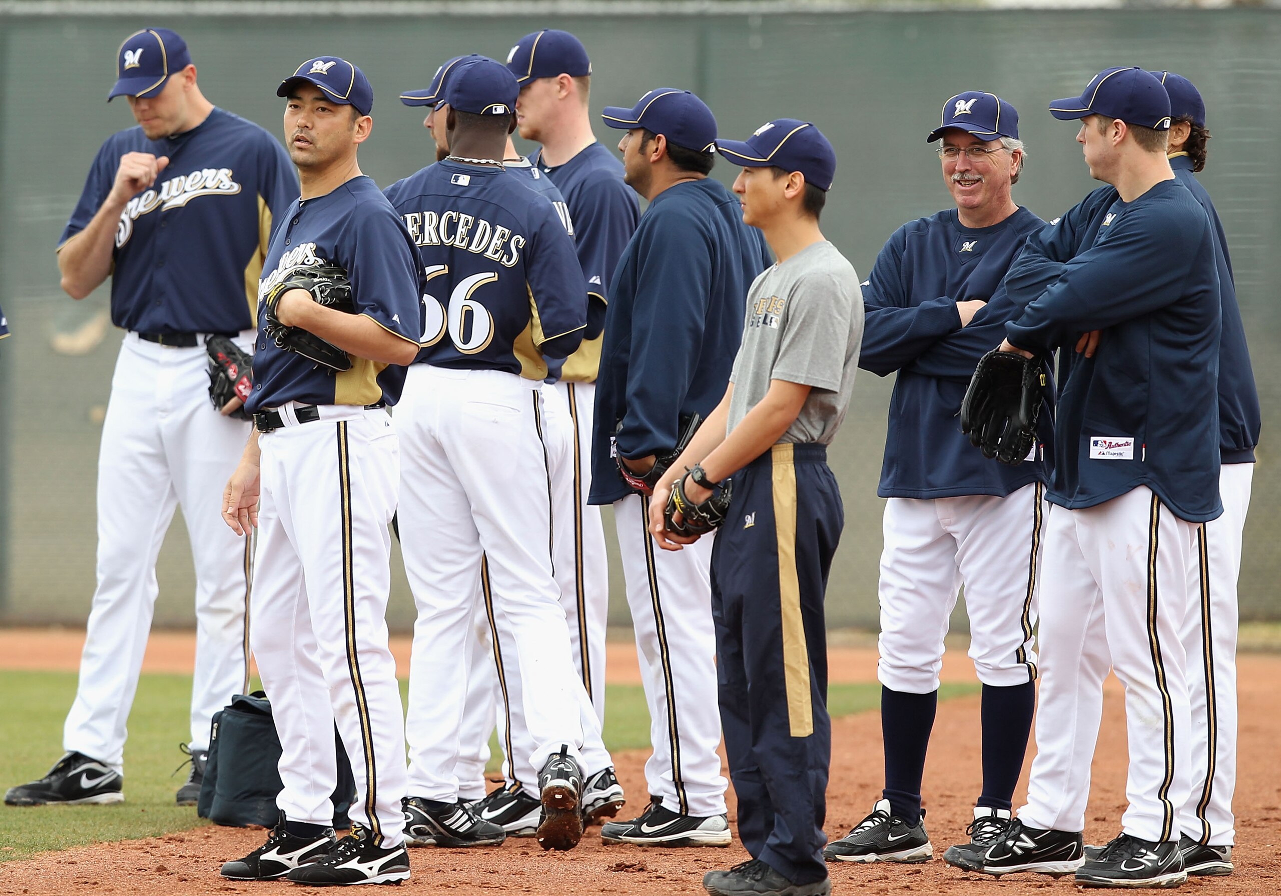 PHOENIX, AZ - FEBRUARY 18:  Pitcher Takashi Saito #40 (2nd from left) of the Milwaukee Brewers warms up with teammates during a MLB spring training practice at Maryvale Baseball Park on February 18, 2011 in Phoenix, Arizona.  (Photo by Christian Petersen/