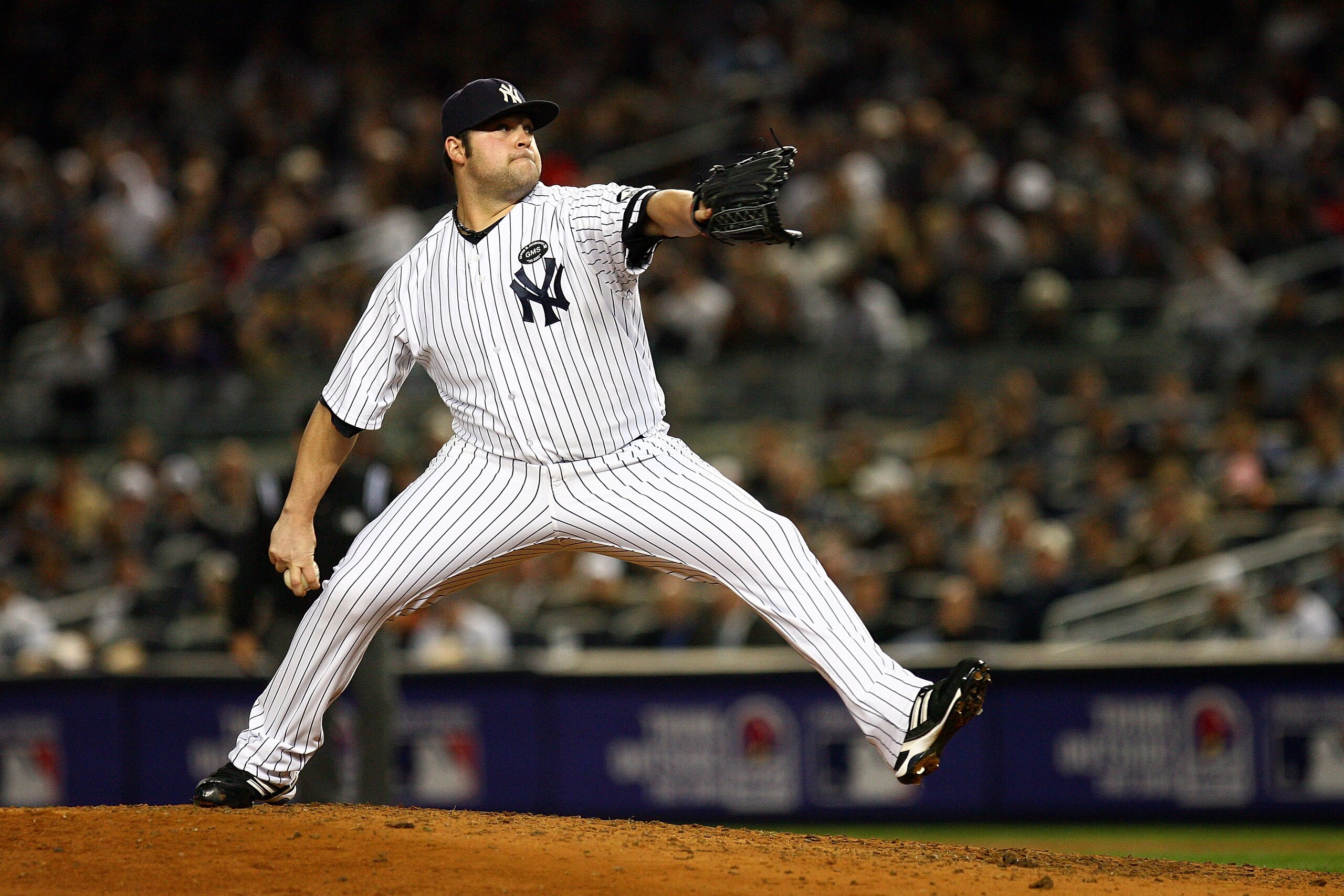 NEW YORK - OCTOBER 19:  Joba Chamberlain #62 of the New York Yankees pitches against the Texas Rangers in Game Four of the ALCS during the 2010 MLB Playoffs at Yankee Stadium on October 19, 2010 in the Bronx borough of New York City.  (Photo by Andrew Bur