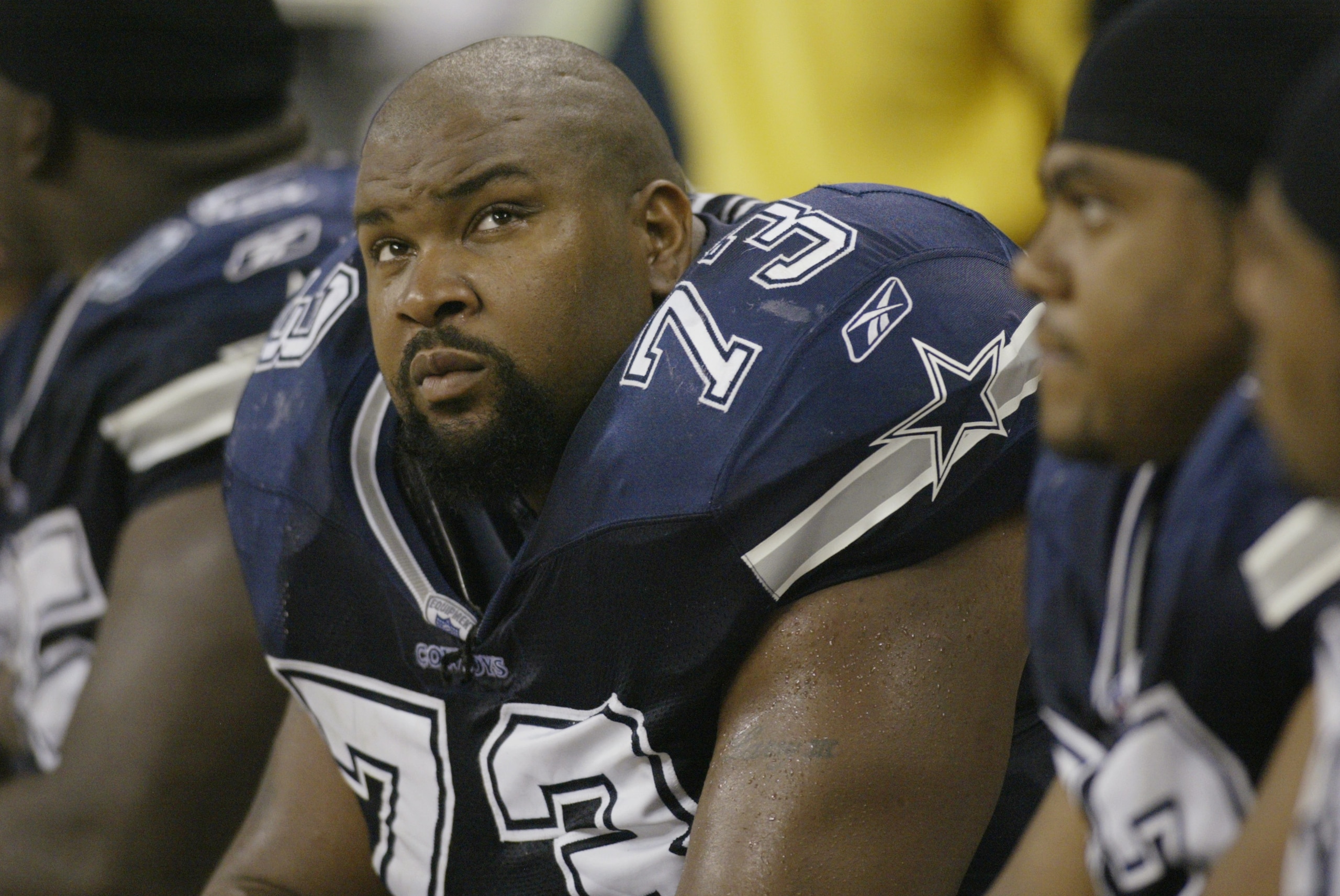 HOUSTON, TX - SEPTEMBER 8:  Guard Larry Allen #73 of the Dallas Cowboys sits on the bench during NFL game against the Houston Texans on September 8, 2002 at Reliant Stadium in Houston, Texas. The Texans won their first regular season game 19-10.  (Photo b