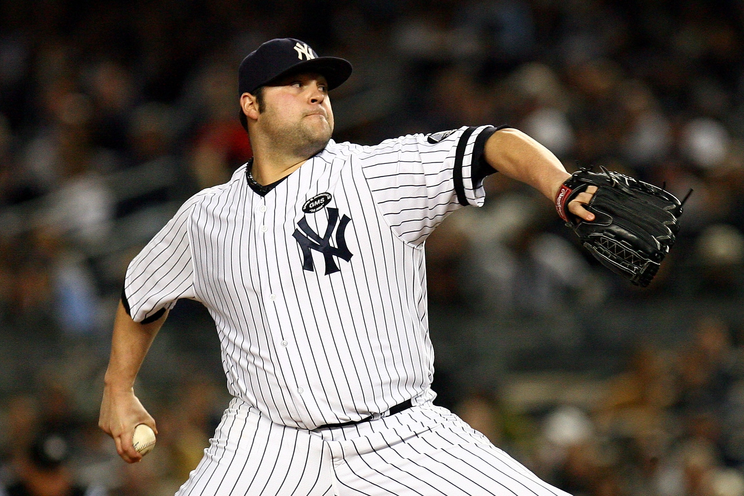 NEW YORK - OCTOBER 19:  Joba Chamberlain #62 of the New York Yankees pitches against the Texas Rangers in Game Four of the ALCS during the 2010 MLB Playoffs at Yankee Stadium on October 19, 2010 in the Bronx borough of New York City.  (Photo by Andrew Bur
