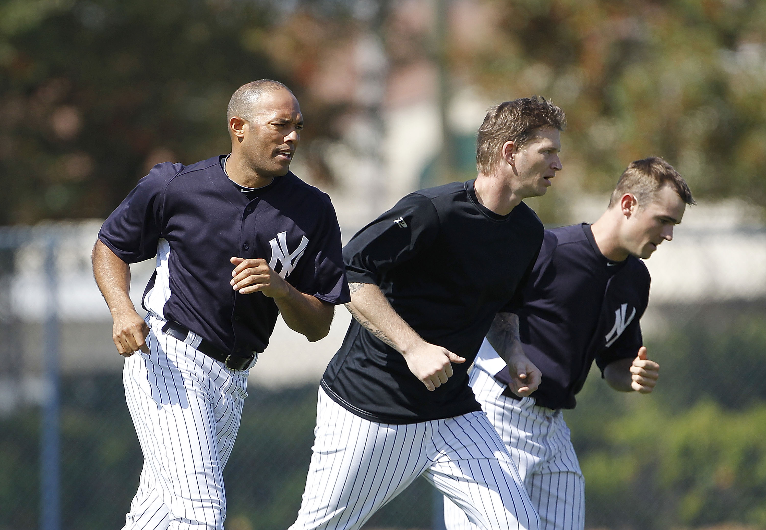 TAMPA, FL - FEBRUARY 21: Mariano Rivera #42, A J Burnett #34, and David Robertson #30 of the New York Yankees work out during the second day of full teams workouts at Spring Training on February 21, 2011 at the George M. Steinbrenner Field in Tampa, Flori