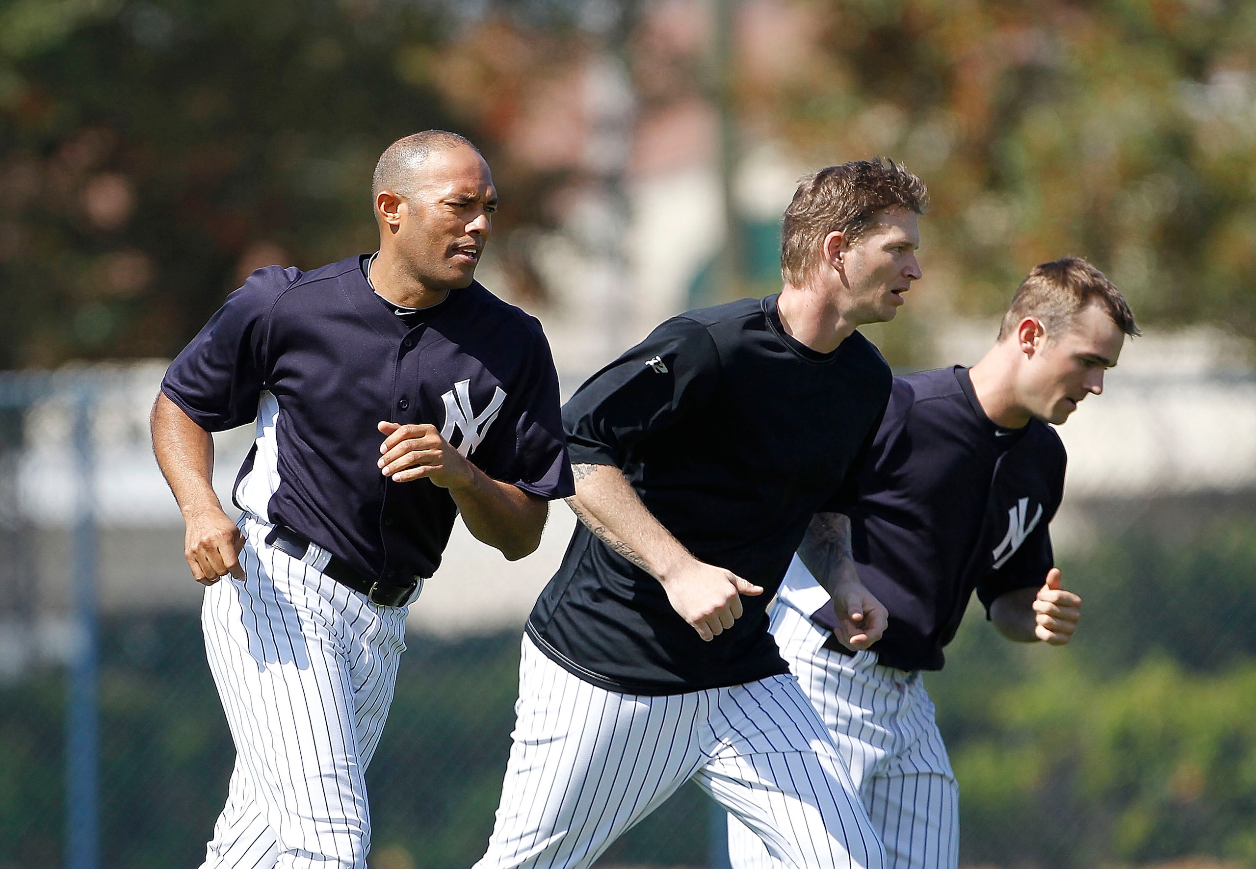 TAMPA, FL - FEBRUARY 21: Mariano Rivera #42, A J Burnett #34, and David Robertson #30 of the New York Yankees work out during the second day of full teams workouts at Spring Training on February 21, 2011 at the George M. Steinbrenner Field in Tampa, Flori