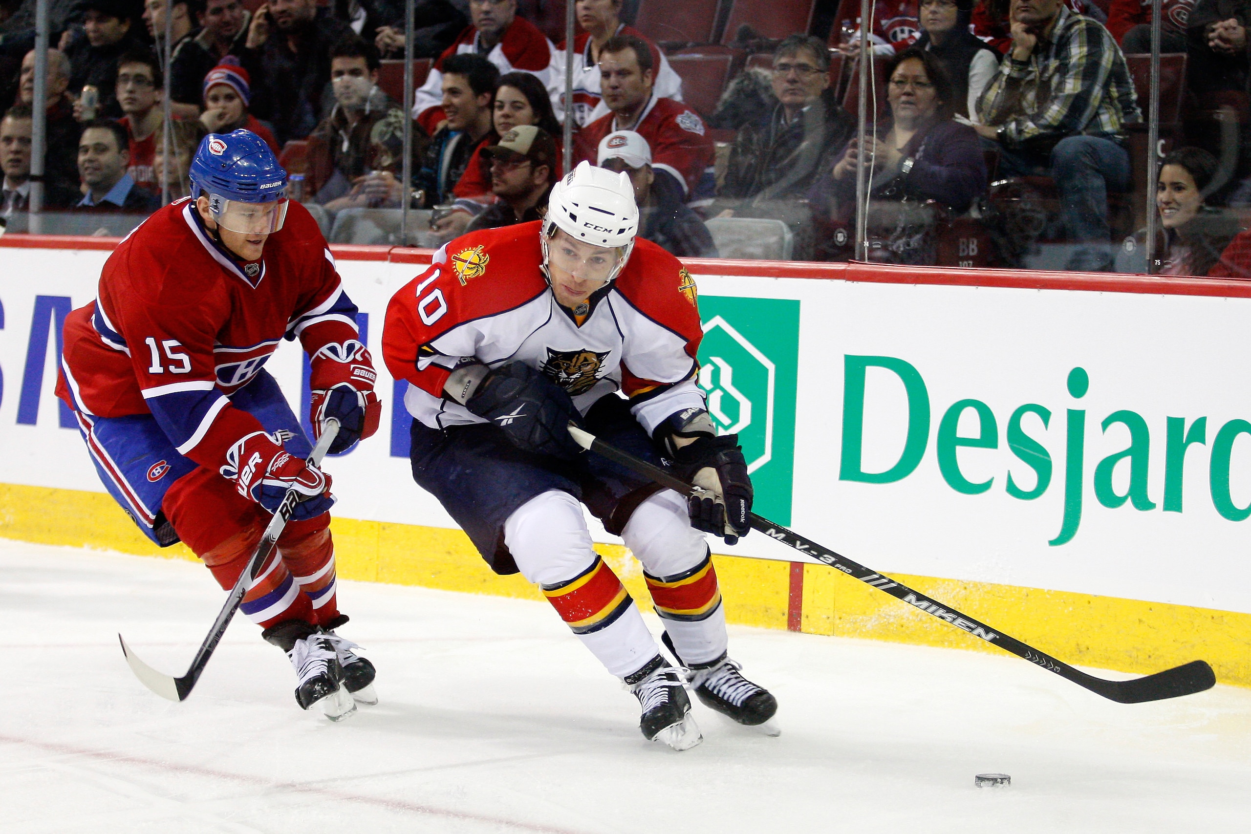 MONTREAL, CANADA - FEBRUARY 2:  David Booth #10 of the Florida Panthers skates with the puck while being chased by Jeff Halpern #15 of the Montreal Canadiens during the NHL game at the Bell Centre on February 2, 2011 in Montreal, Quebec, Canada.  The Cana