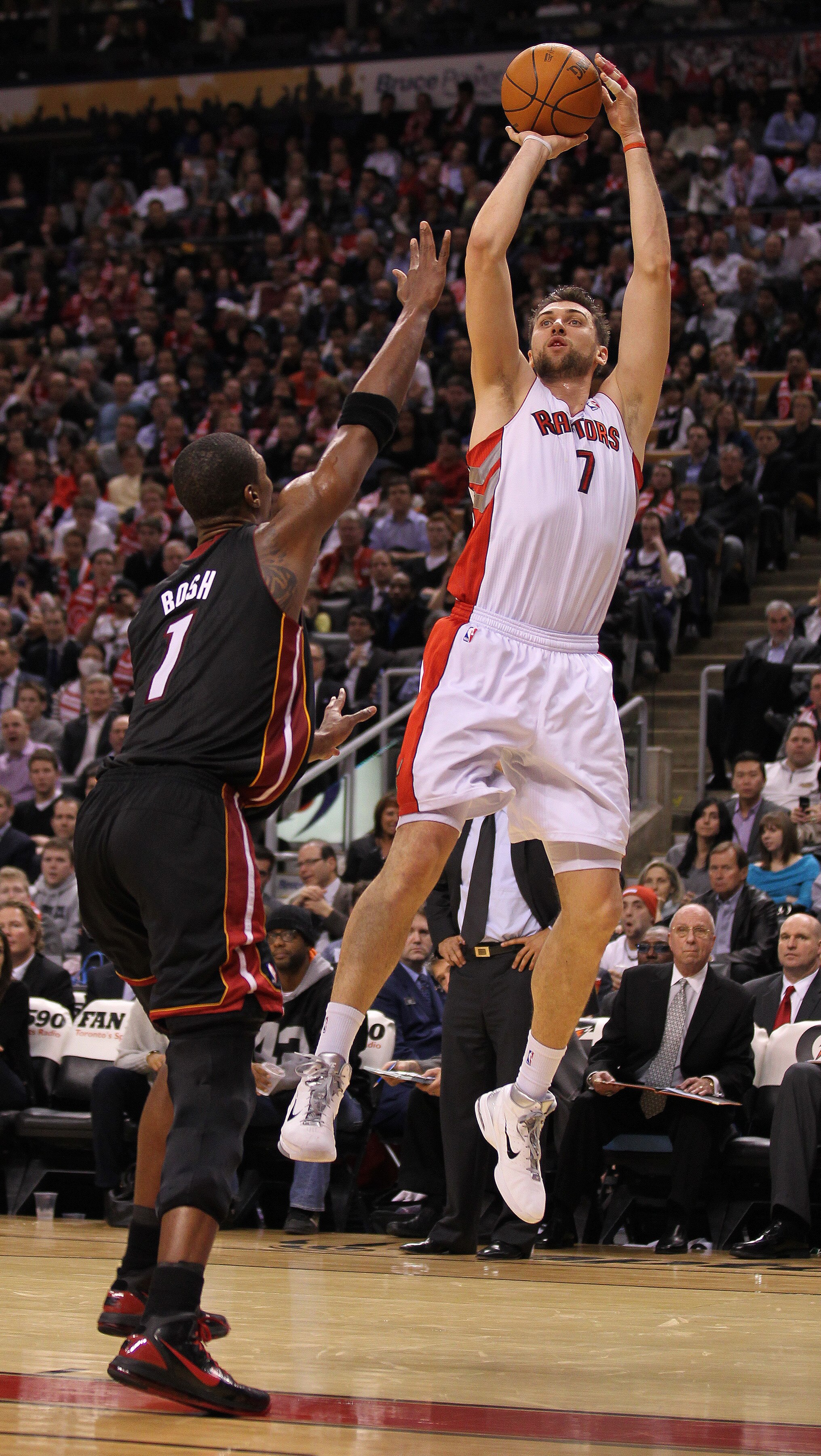 TORONTO, CAN - FEBRUARY 16:  Andrea Bargnani #7 of the Toronto Raptors shoots over Chris Bosh #1 of the Miami Heat in a game on February 16, 2011 at the Air Canada Centre in Toronto, Canada. The Heat defeated the Raptors 103-95. (Photo by Claus Andersen/G