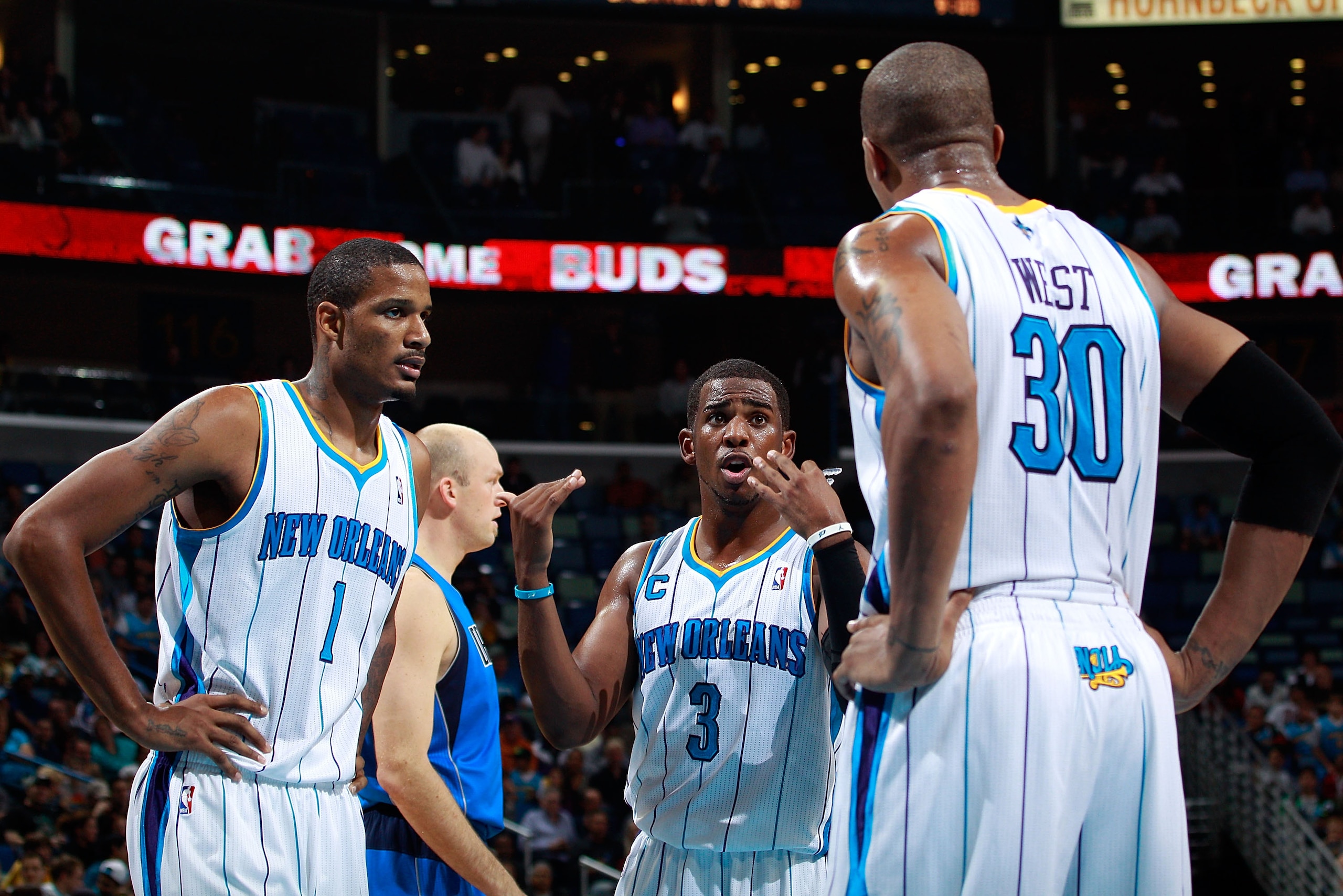 NEW ORLEANS - NOVEMBER 17: Chris Paul #3 talks with Trevor Ariza #1 and David West #30 of the New Orleans Hornets during a timeout against the Dallas Mavericks at the New Orleans Arena on November 17, 2010 in New Orleans, Louisiana. The Hornets defeated NEW ORLEANS - NOVEMBER 17: Chris Paul #3 talks with Trevor Ariza #1 and David West #30 of the New Orleans Hornets during a timeout against the Dallas Mavericks at the New Orleans Arena on November 17, 2010 in New Orleans, Louisiana. The Hornets defeated