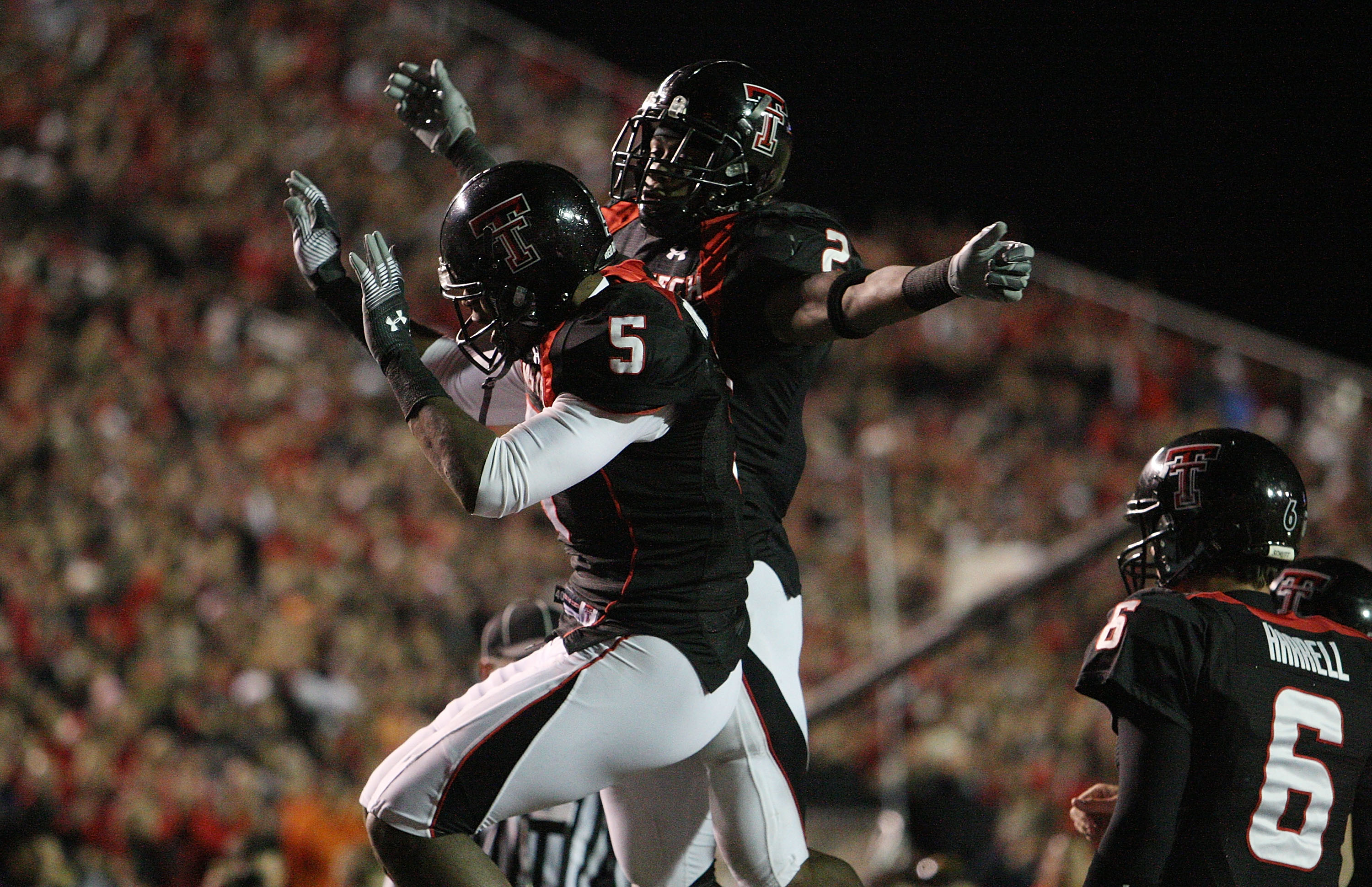 LUBBOCK, TX - NOVEMBER 08:  Wide receiver Michael Crabtree #5 of the Texas Tech Red Raiders celebrates a touchdown with Shannon Woods #2 during play against the Oklahoma State Cowboys at Jones AT&T Stadium on November 8, 2008 in Lubbock, Texas.  (Photo by