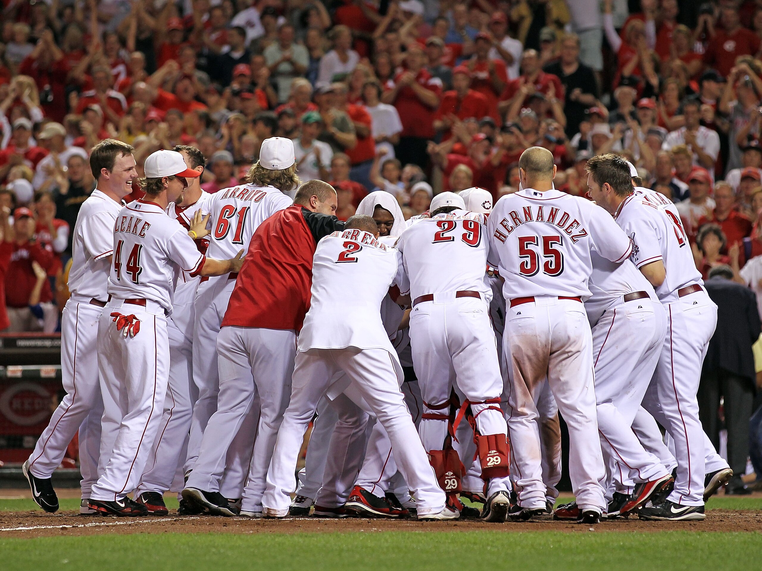 CINCINNATI - SEPTEMBER 11: Joey Votto #19 of the Cincinnati Reds is mobbed by his teammates after hitting a game winning home run during the game against the Pittsburg Pirates at Great American Ball Park on September 11, 2010 in Cincinnati, Ohio. The Red CINCINNATI - SEPTEMBER 11: Joey Votto #19 of the Cincinnati Reds is mobbed by his teammates after hitting a game winning home run during the game against the Pittsburg Pirates at Great American Ball Park on September 11, 2010 in Cincinnati, Ohio. The Red