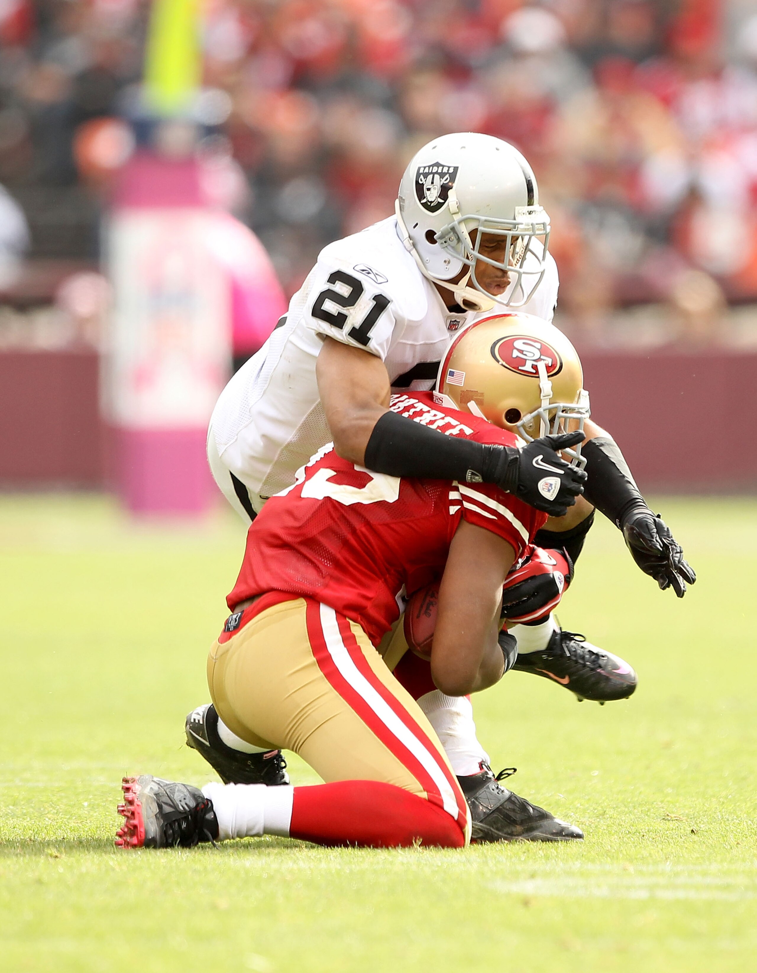 SAN FRANCISCO - OCTOBER 17: Nnamdi Asomugha #21 of the Oakland Raiders tackles Michael Crabtree #15 of the San Francisco 49ers at Candlestick Park on October 17, 2010 in San Francisco, California. (Photo by Ezra Shaw/Getty Images) SAN FRANCISCO - OCTOBER 17: Nnamdi Asomugha #21 of the Oakland Raiders tackles Michael Crabtree #15 of the San Francisco 49ers at Candlestick Park on October 17, 2010 in San Francisco, California. (Photo by Ezra Shaw/Getty Images)