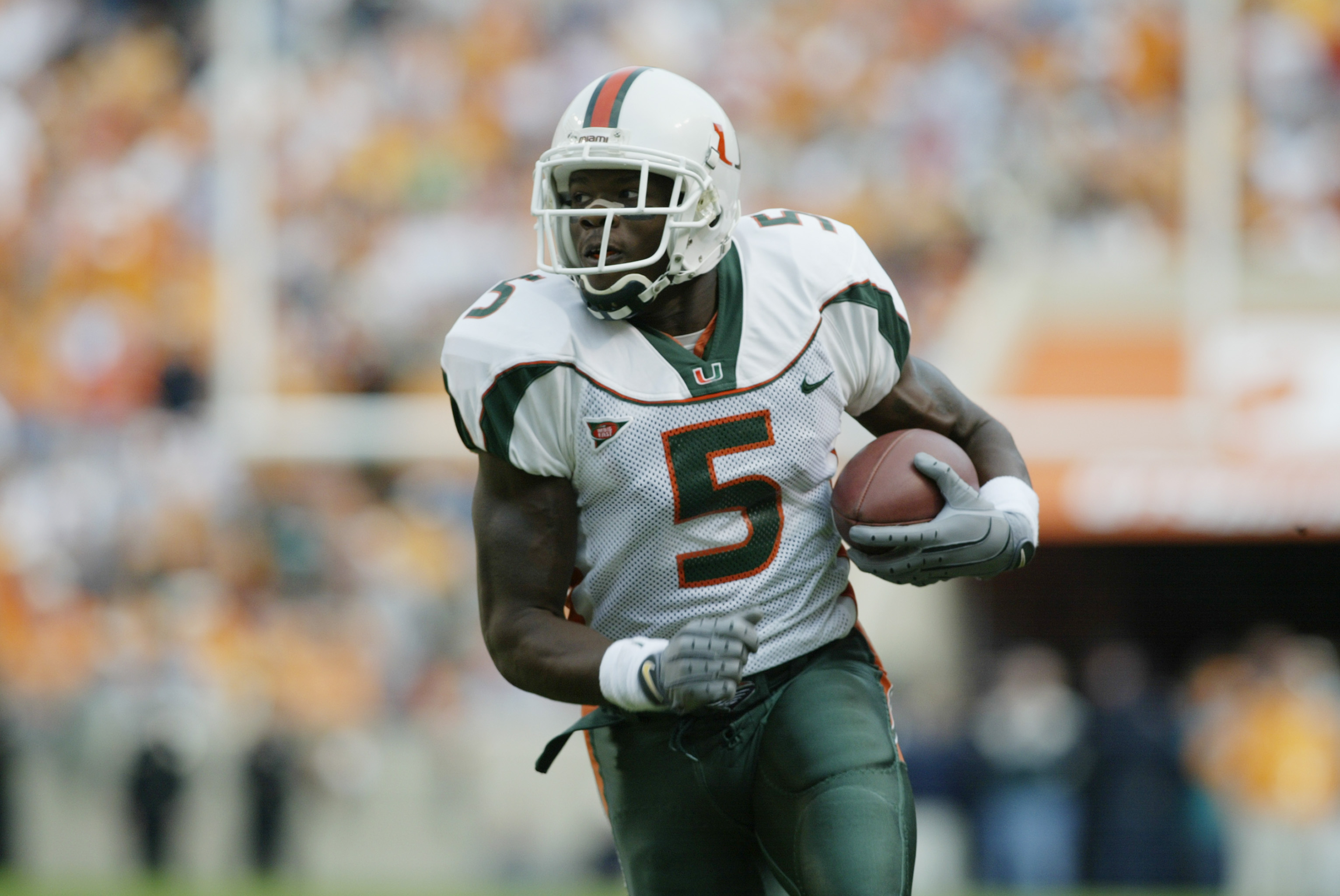 KNOXVILLE,TN - NOVEMBER 9:  Wide reciever Andre Johnson #5 of Miami carries the ball during the game against the Tennessee on November 9, 2002 at the Neyland Stadium in Knoxville, Tennessee.  (Photo by Andy Lyons/Getty Images)