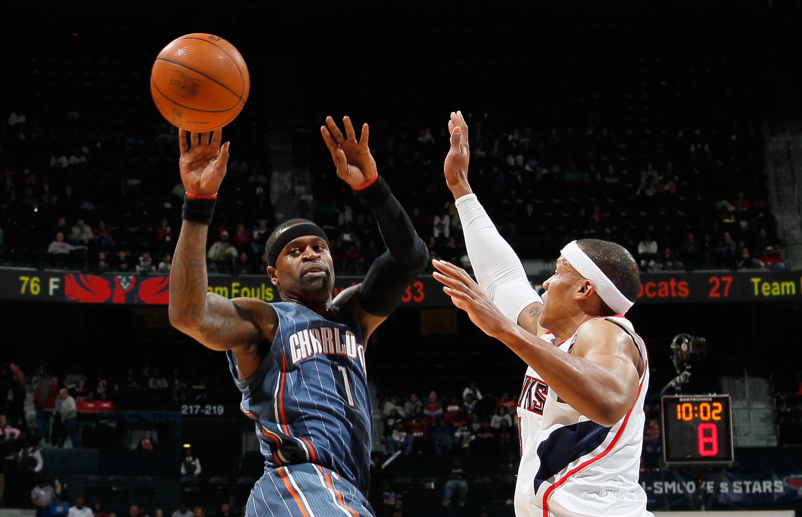 ATLANTA, GA - FEBRUARY 12:  Stephen Jackson #1 of the Charlotte Bobcats passes the ball against Maurice Evans #1 of the Atlanta Hawks at Philips Arena on February 12, 2011 in Atlanta, Georgia.  NOTE TO USER: User expressly acknowledges and agrees that, by