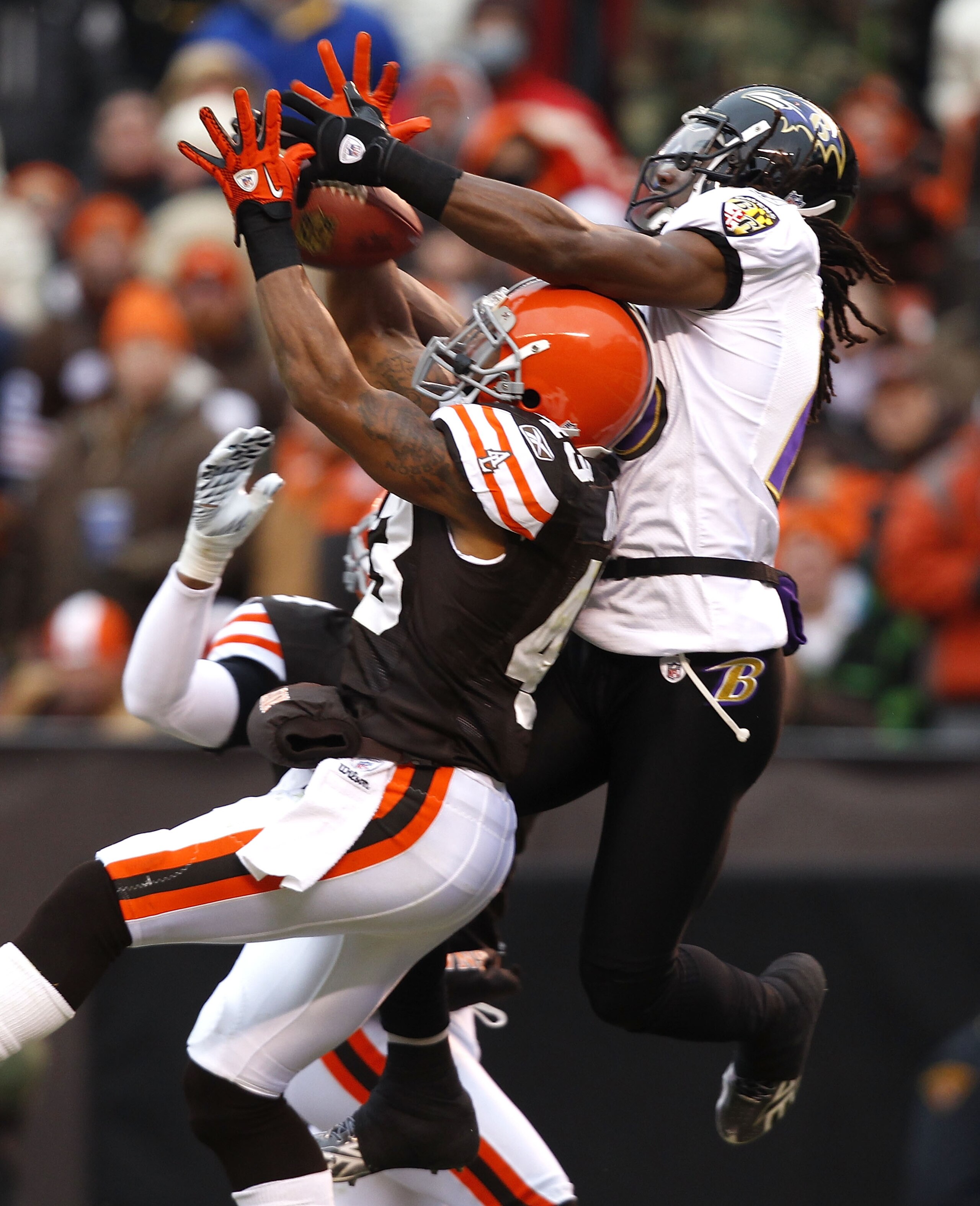 CLEVELAND - DECEMBER 26:  Wide receiver Donte' Stallworth #18 of the Baltimore Ravens goes up for a catch with defensive back T.J. Ward #43 of the Cleveland Browns at Cleveland Browns Stadium on December 26, 2010 in Cleveland, Ohio.  (Photo by Matt Sulliv