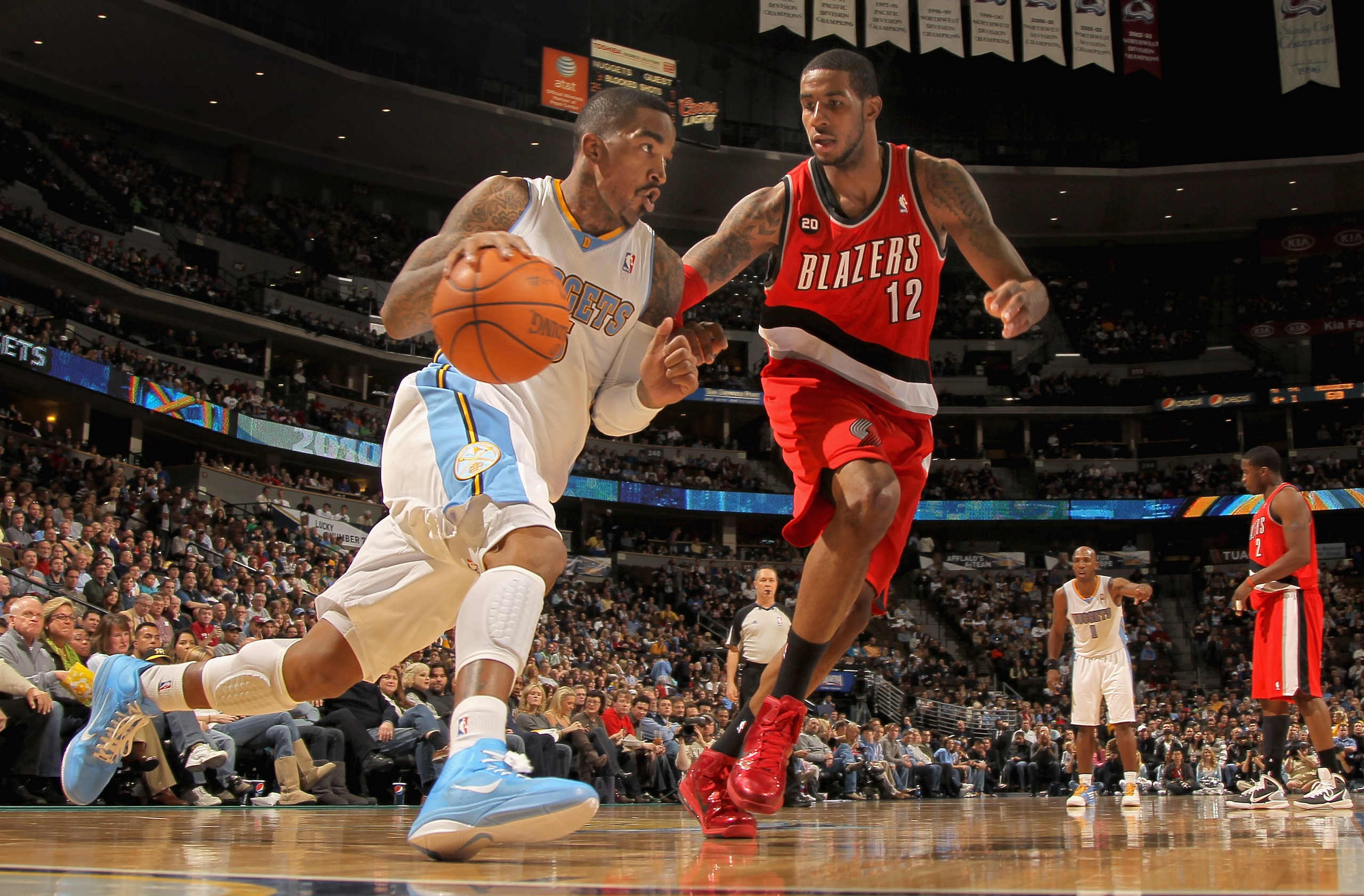 DENVER - DECEMBER 28: J.R. Smith #5 of the Denver Nuggets drives around LaMarcus Aldridge #12 of the Portland Trail Blazers at Pepsi Center on December 28, 2010 in Denver, Colorado. The Nuggets defeated the Blazers 95-77. NOTE TO USER: User expressly ack DENVER - DECEMBER 28: J.R. Smith #5 of the Denver Nuggets drives around LaMarcus Aldridge #12 of the Portland Trail Blazers at Pepsi Center on December 28, 2010 in Denver, Colorado. The Nuggets defeated the Blazers 95-77. NOTE TO USER: User expressly ack