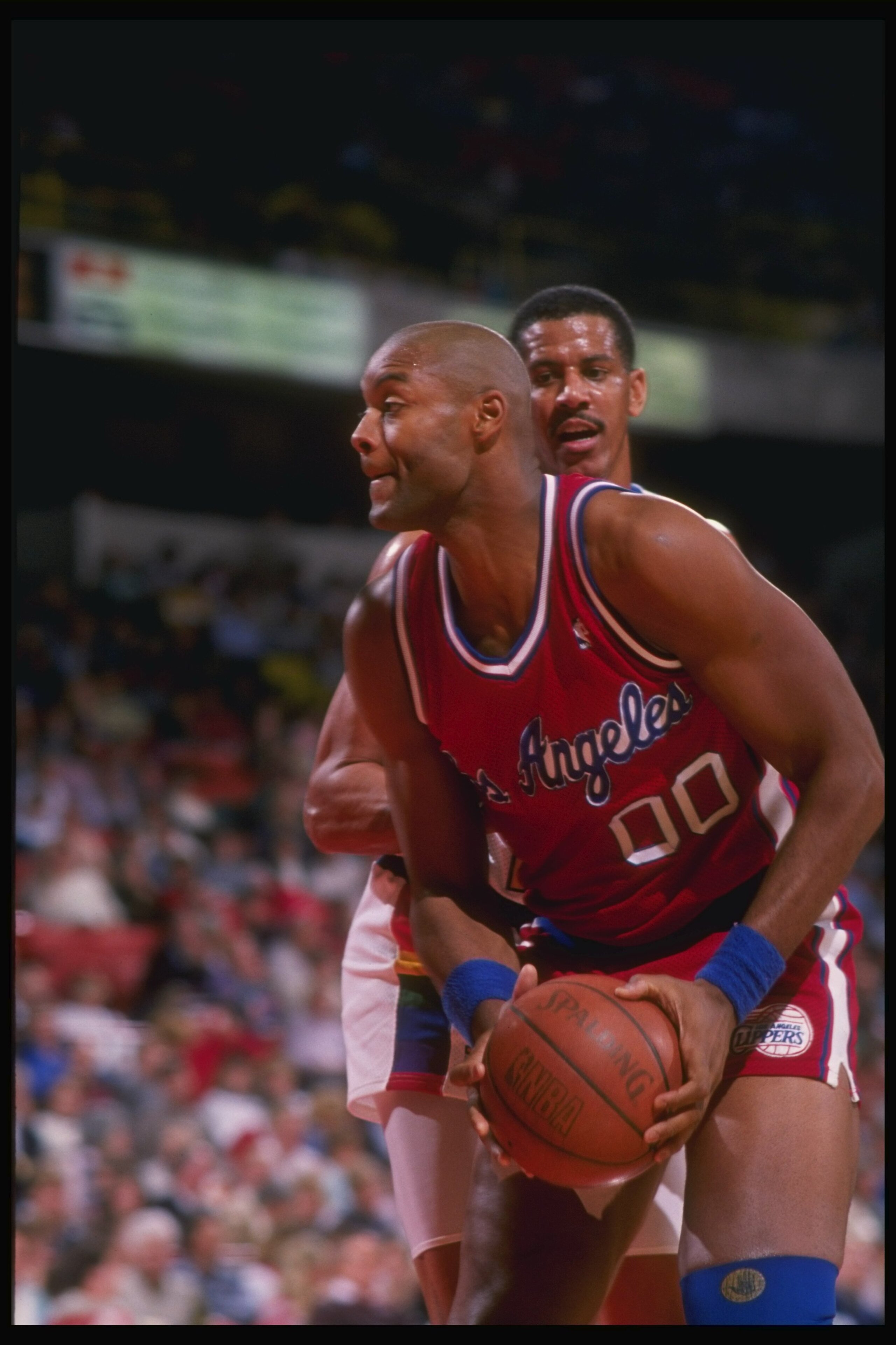 1988-1989:  Center Benoit Benjamin of the Los Angeles Clippers (right) keeps the ball away from Joe Cooper of the Denver Nuggets during a game at the McNichols Arena in Denver, Colorado. Mandatory Credit: Mike Powell  /Allsport