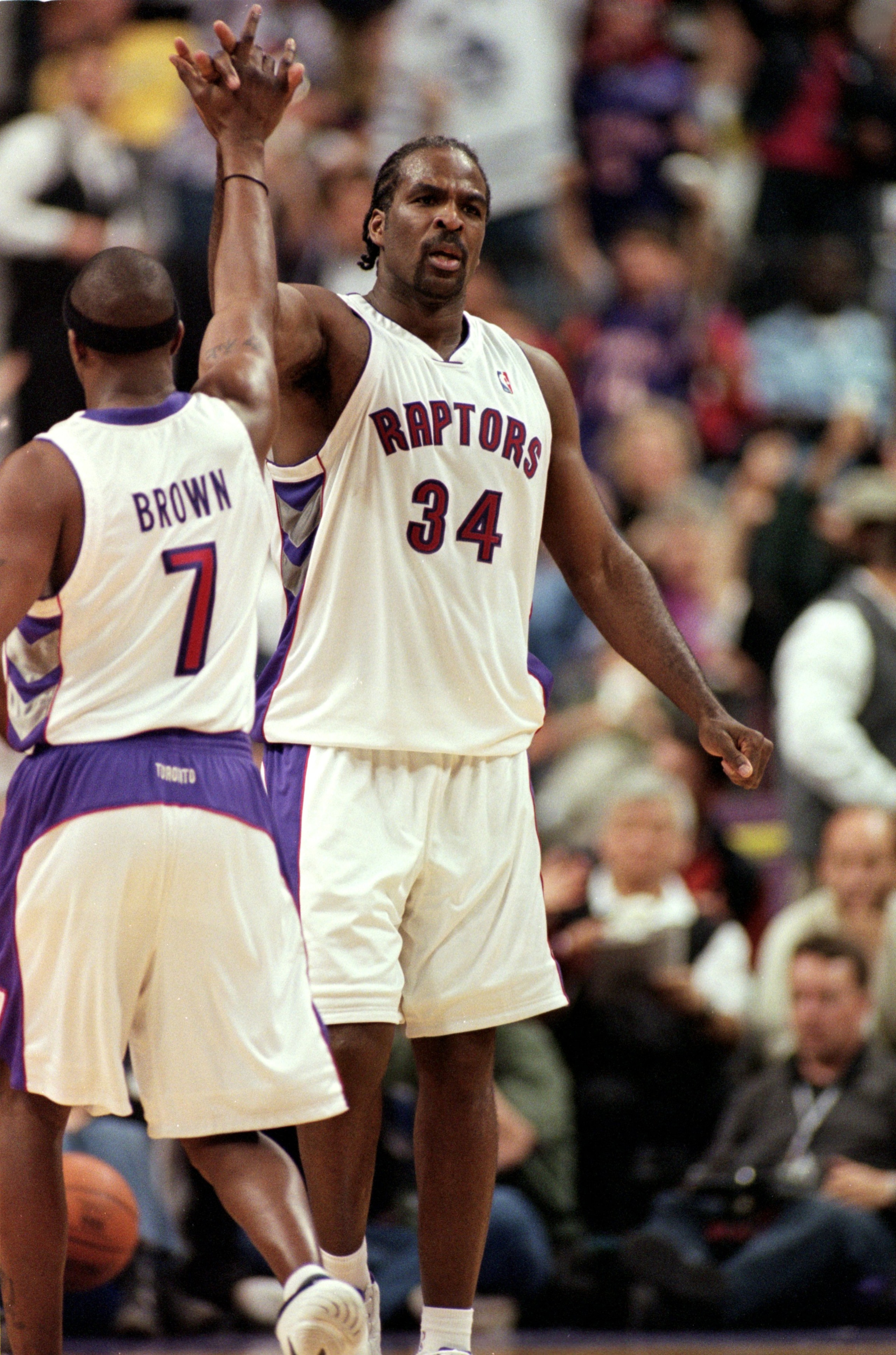 30 Apr 2000:  Charles Oakley #34 of the Toronto Raptors gets high fived by Dee Brown #7 (L-R) during the NBA Eastern Conference Playoffs Round One Game against the New York Knicks at the Air Canada Centre in Toronto, Ontario, Canada. The Knicks defeated t