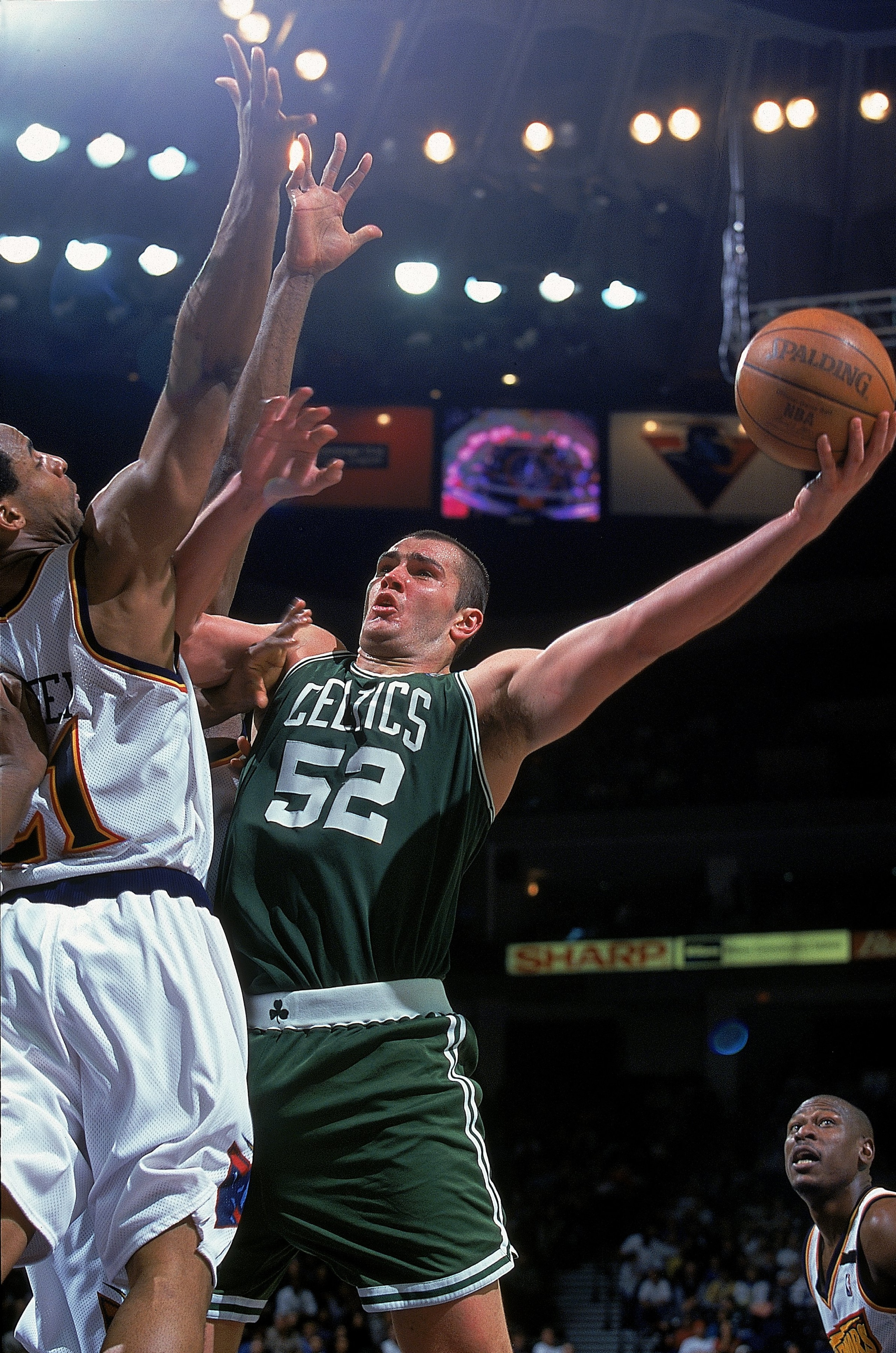 18 Feb 2000: Vitaly Potapenko #52 of the Boston Celtics jumps for the basket as he is guarded during a game against the Golden State Warriors at the Oakland Coliseum in Oakland, California. The Warriors defeated the Celtics 122-100.    Mandatory Credit: J