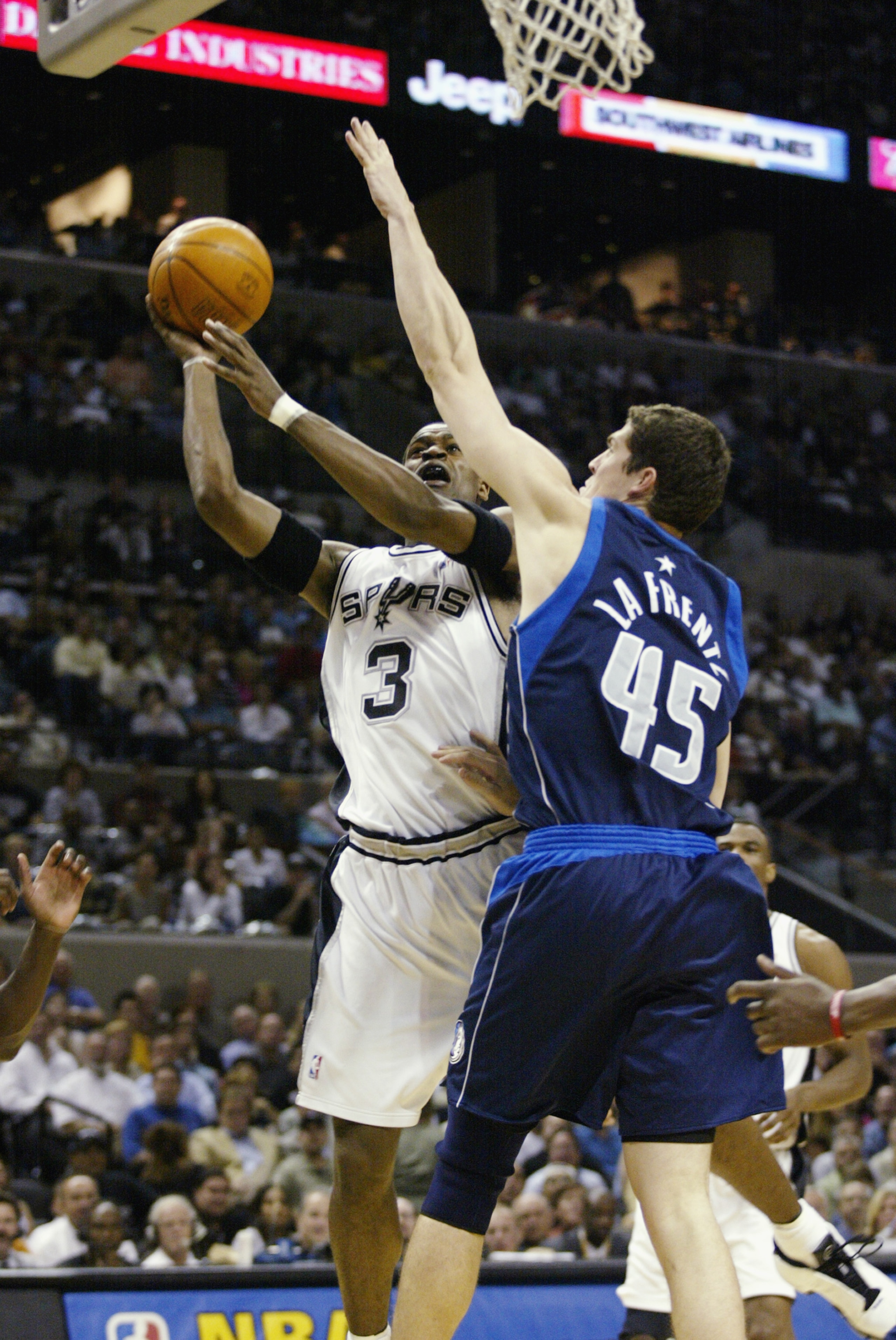 SAN ANTONIO - MAY 27:  Stephen Jackson #3 of the San Antonio Spurs puts a shot up over Raef LaFrentz #45 of the Dallas Mavericks in Game five of the Western Conference Finals during the 2003 NBA Playoffs at SBC Center on May 27, 2003 in San Antonio, Texas