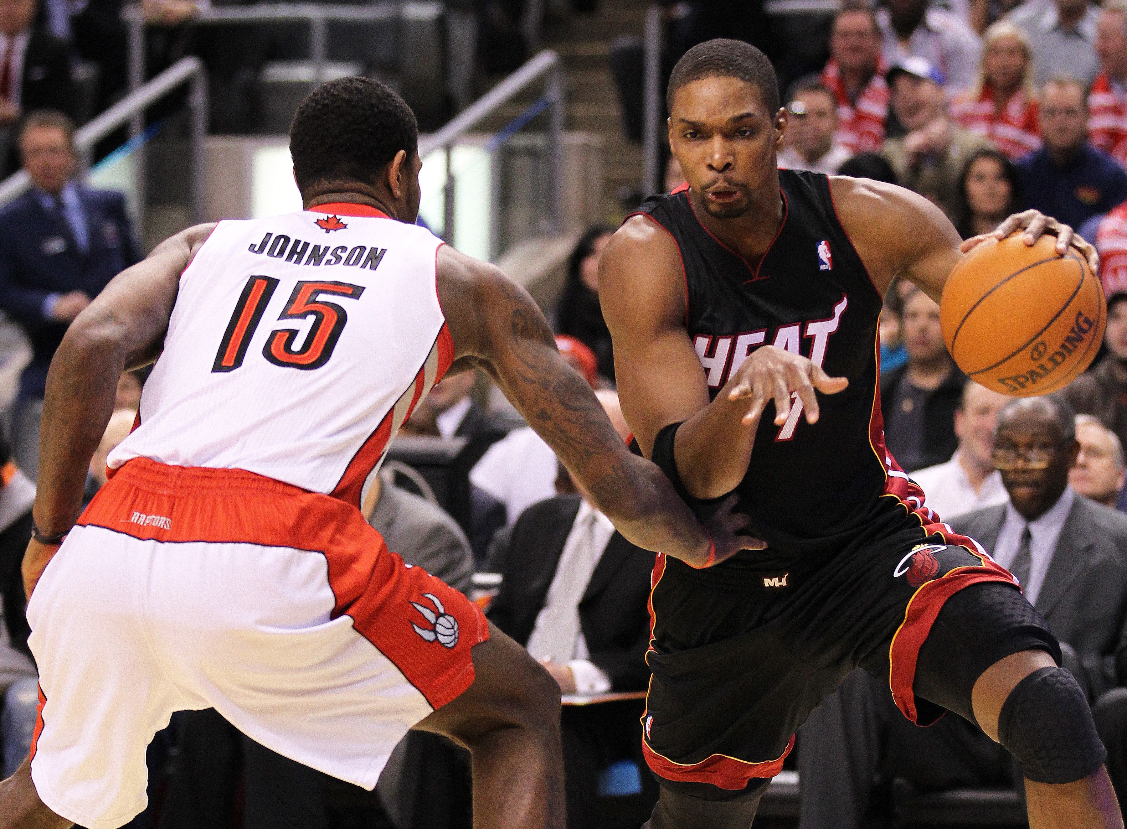 TORONTO, CAN - FEBRUARY 16:  Chris Bosh #1 of the Miami Heat drives around Amir Johnson #15 of the Toronto Raptors in a game on February 16, 2011 at the Air Canada Centre in Toronto, Canada. (Photo by Claus Andersen/Getty Images)