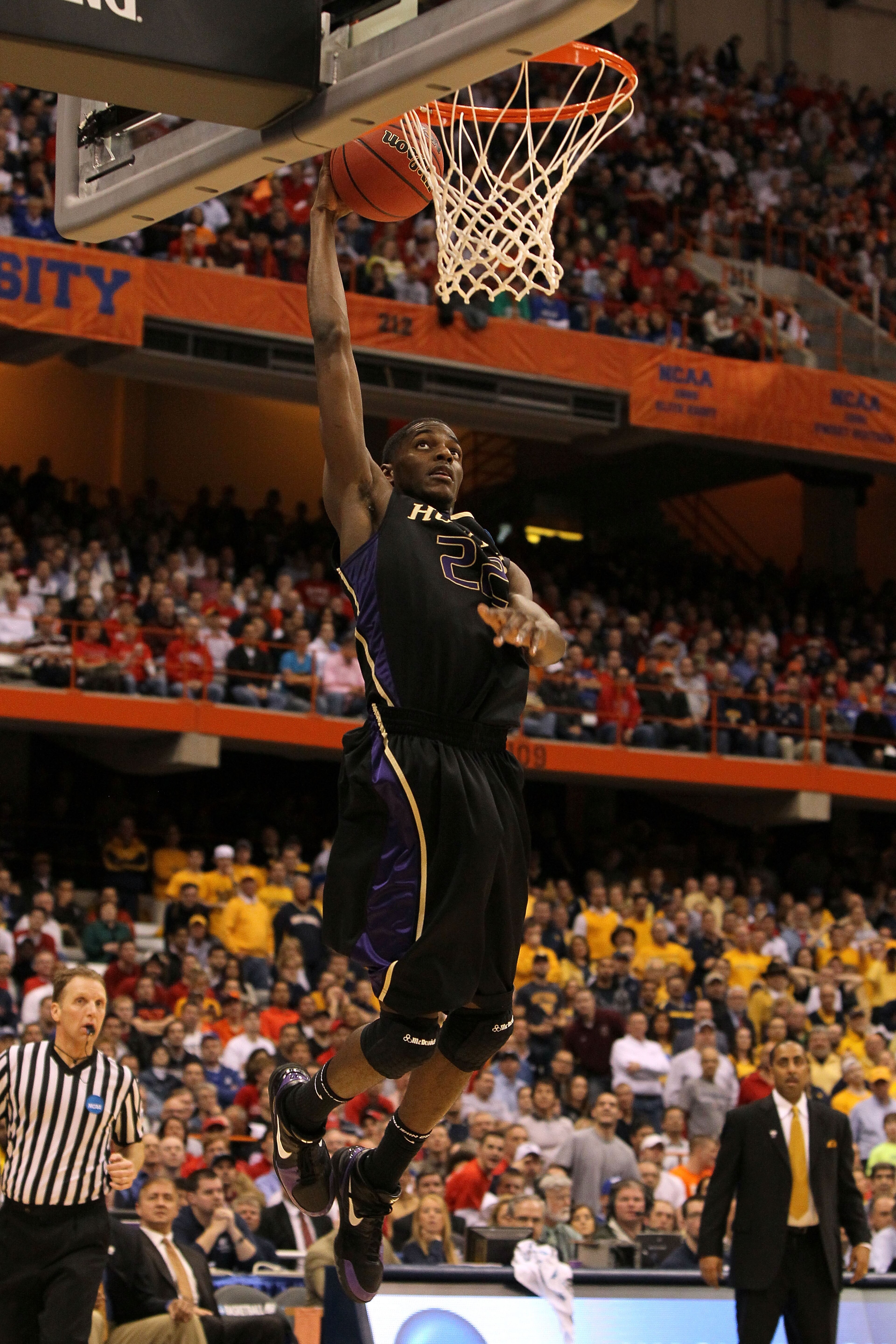 SYRACUSE, NY - MARCH 25: Justin Holiday #22 of the Washington Huskies dunks against the West Virginia Mountaineers during the east regional semifinal of the 2010 NCAA men's basketball tournament at the Carrier Dome on March 25, 2010 in Syracuse, New York SYRACUSE, NY - MARCH 25: Justin Holiday #22 of the Washington Huskies dunks against the West Virginia Mountaineers during the east regional semifinal of the 2010 NCAA men's basketball tournament at the Carrier Dome on March 25, 2010 in Syracuse, New York
