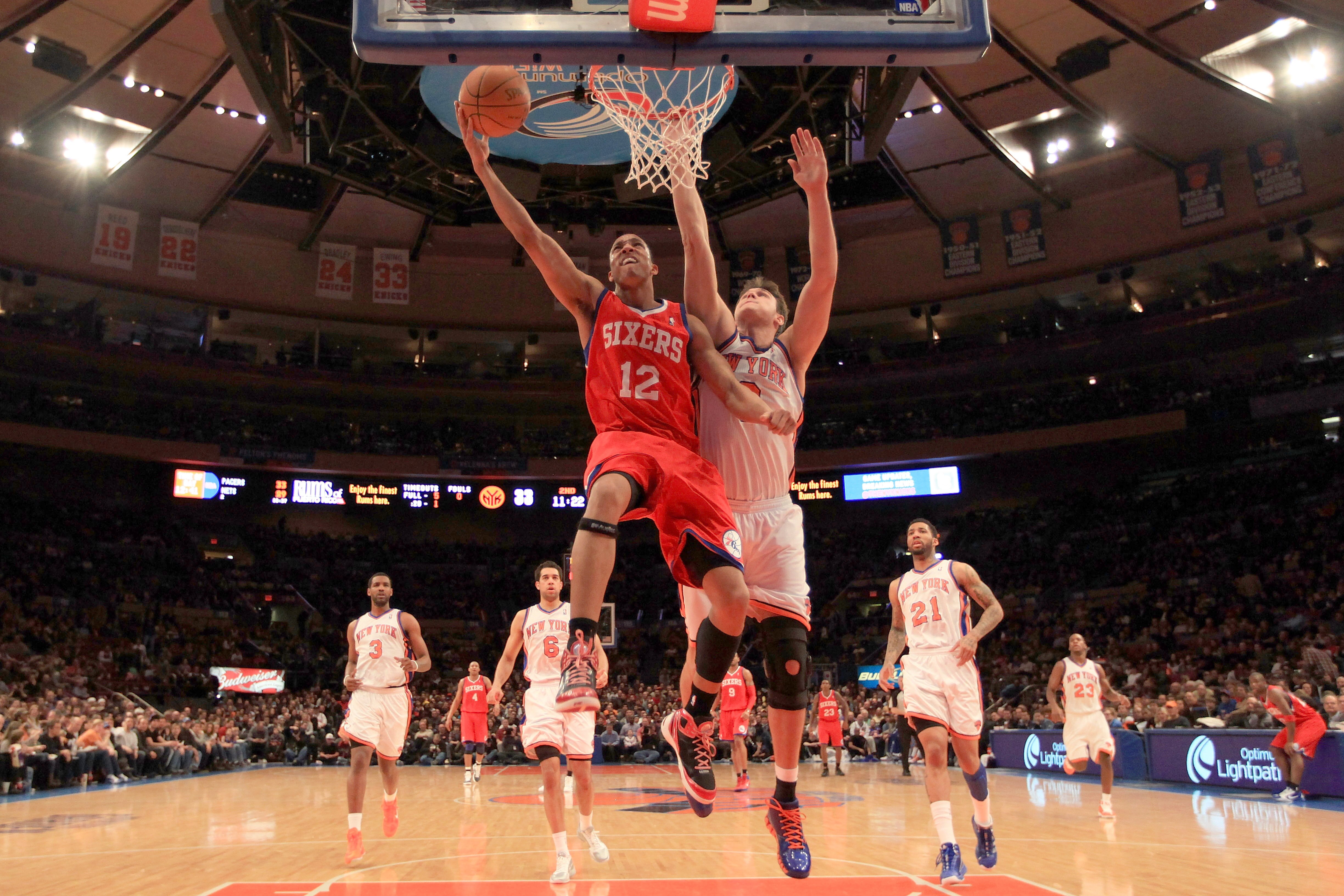 NEW YORK, NY - FEBRUARY 06:  Evan Turner #12 of the Philadelphia 76ers lays the ball up over Danilo Gallinari #12 of the New York Knicks at Madison Square Garden on February 6, 2011 in New York City. NOTE TO USER: User expressly acknowledges and agrees th