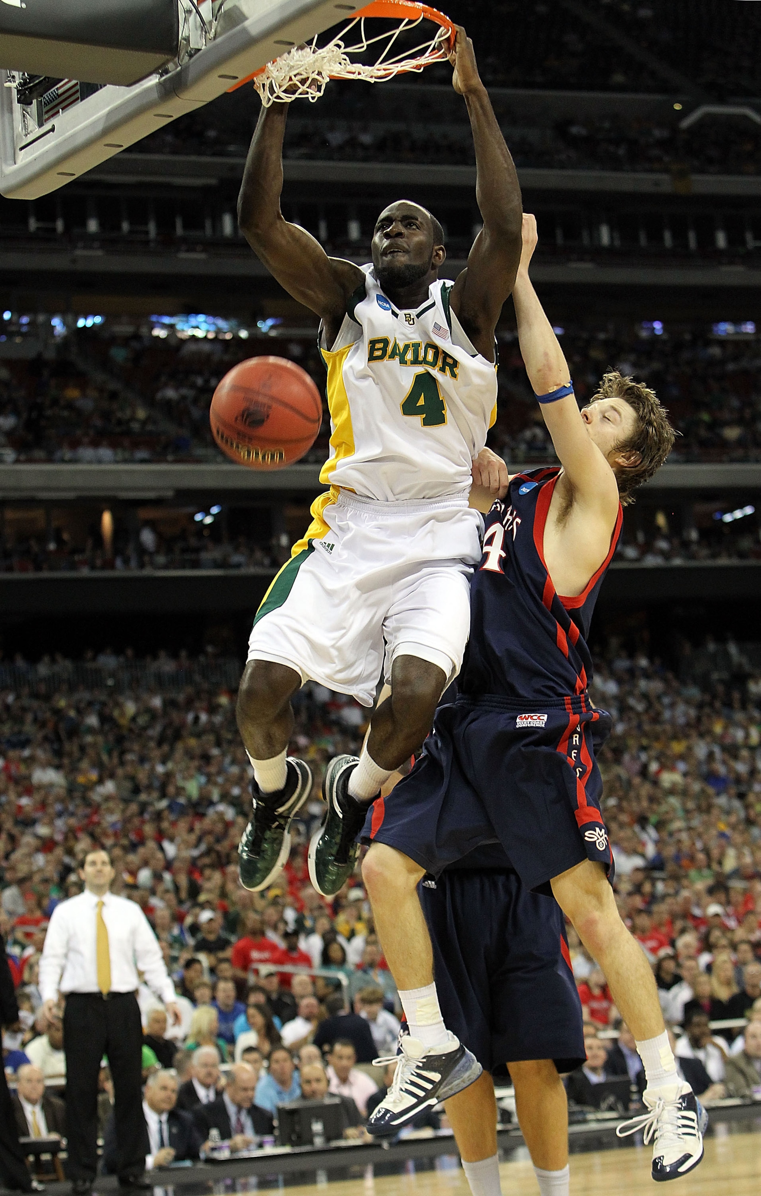 HOUSTON - MARCH 26:  Forward Quincy Acy #4 of the Baylor Bears makes a slam dunk against Matthew Dellavedova #4 of the St. Mary's Gaels during the south regional semifinal of the 2010 NCAA men's basketball tournament at Reliant Stadium on March 26, 2010 i