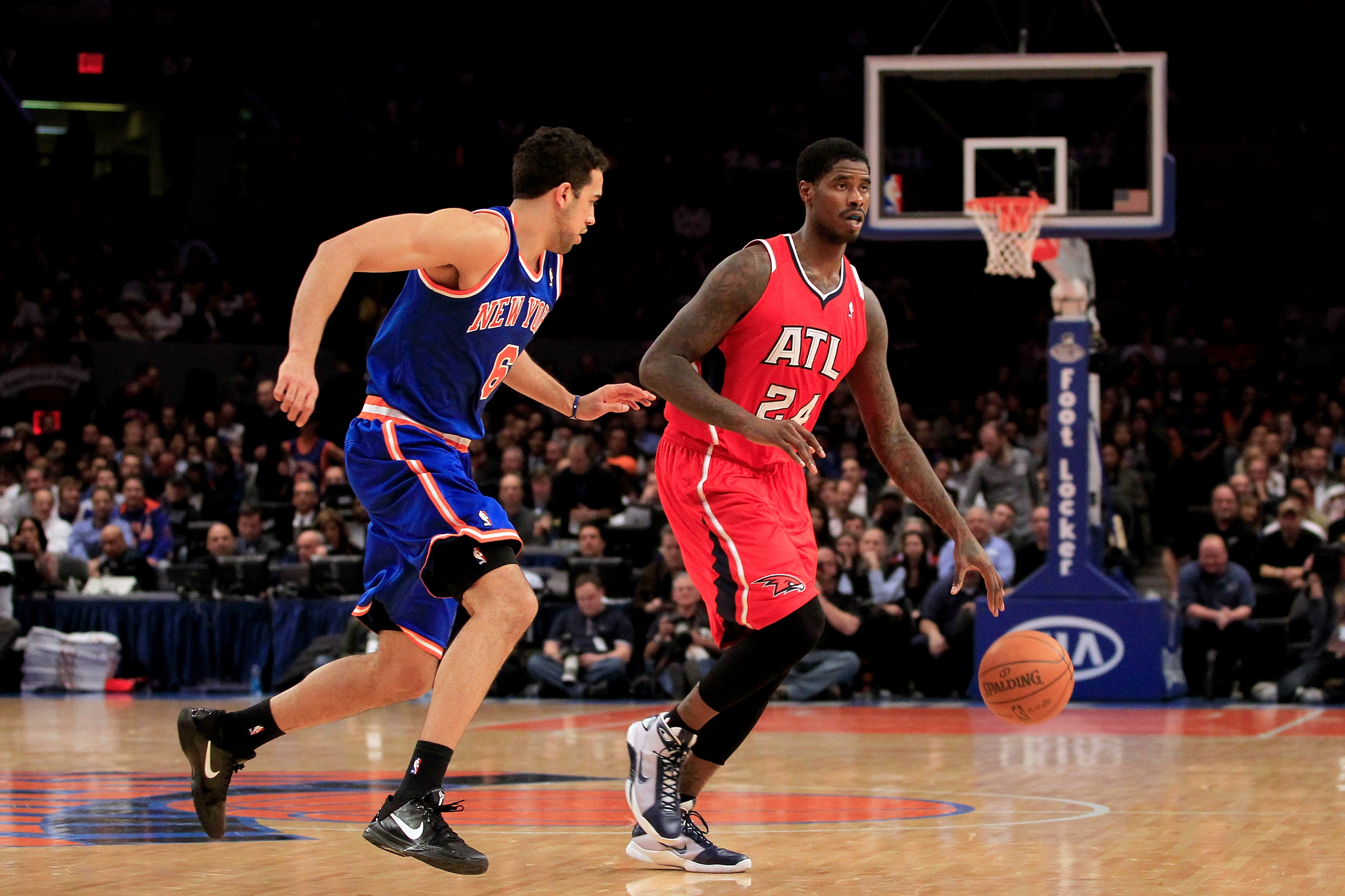 NEW YORK, NY - FEBRUARY 16:  Marvin Williams #24  of the Atlanta Hawks dribbles against Landry Fields #6 of the New York Knicks at Madison Square Garden on February 16, 2011 in New York City. NOTE TO USER: User expressly acknowledges and agrees that, by d