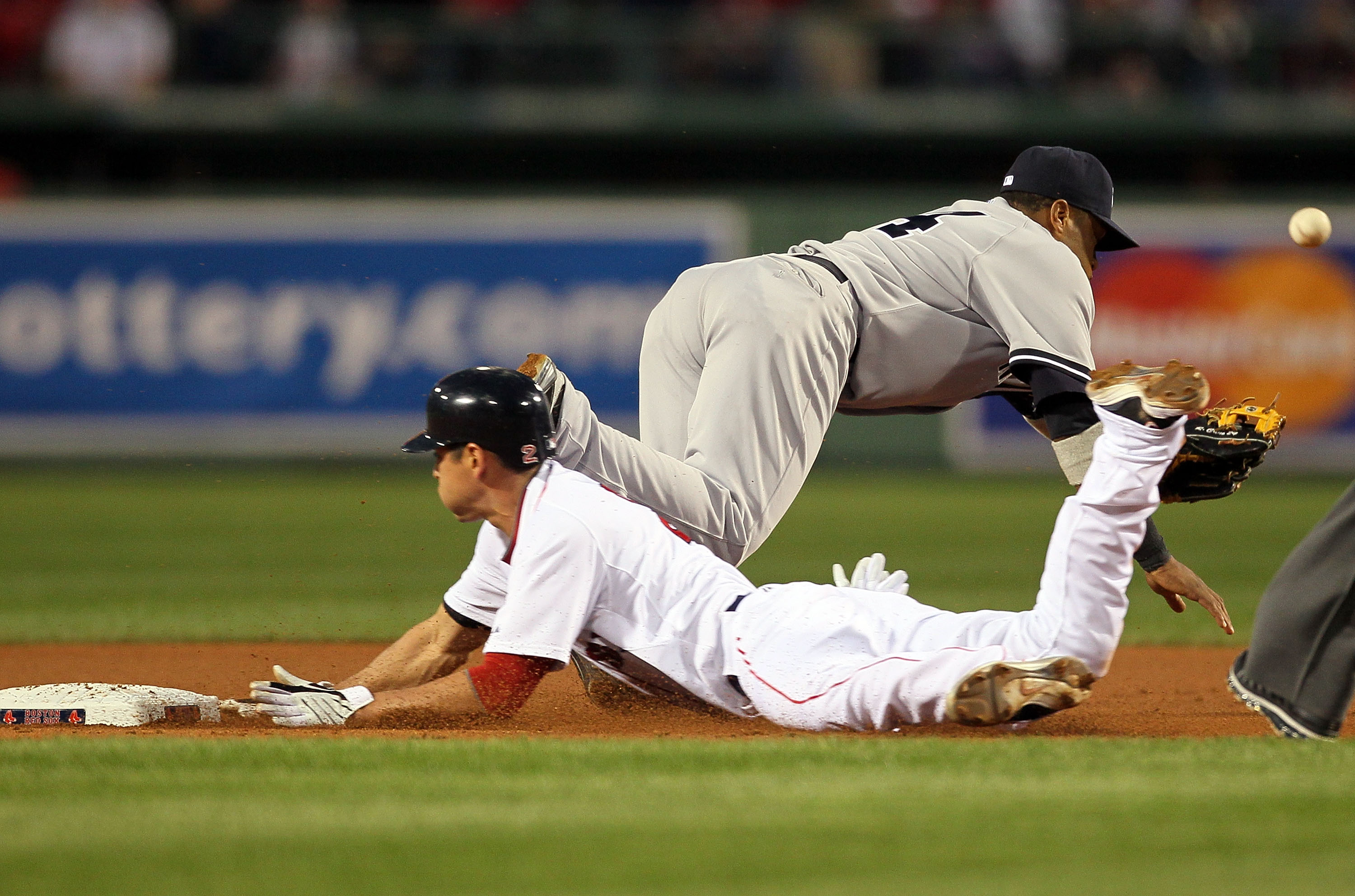 BOSTON - APRIL 06:  Jacoby Ellsbury #2 of the Boston Red Sox steals second as Robinson Cano #24 of the New york Yankees attempts to field an errant at Fenway Park on April 6, 2010 in Boston, Massachusetts. (Photo by Jim Rogash/Getty Images)