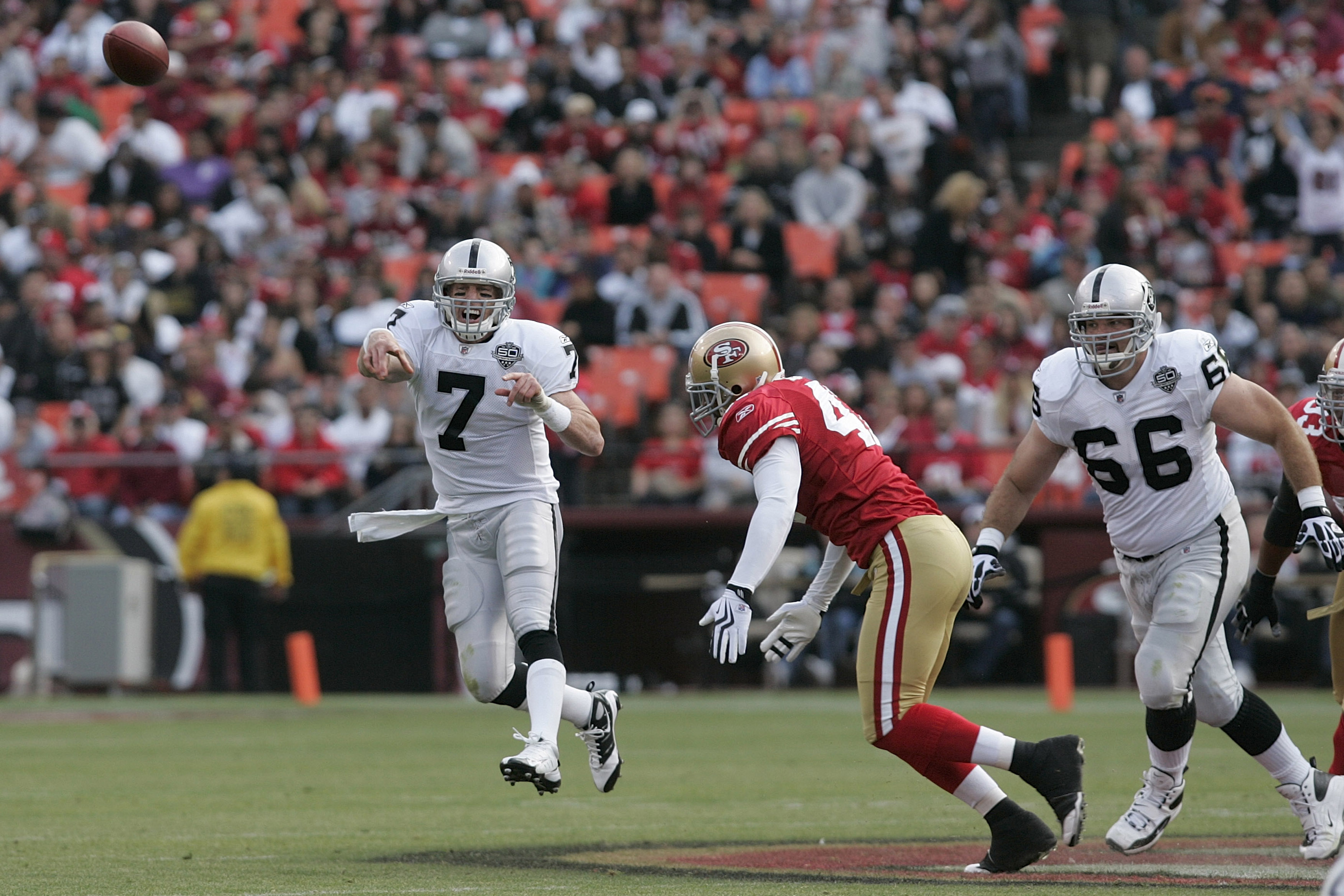 SAN FRANCISCO - AUGUST 22:  Oakland Raiders quarterback Jeff Garcia #7 gets rid of the ball as he is pressured by San Francisco 49ers linebacker Diyral Briggs #47 as Oakland Raiders guard Cooper Carlisle #66 looks on during the 2nd quarter as the San Fran