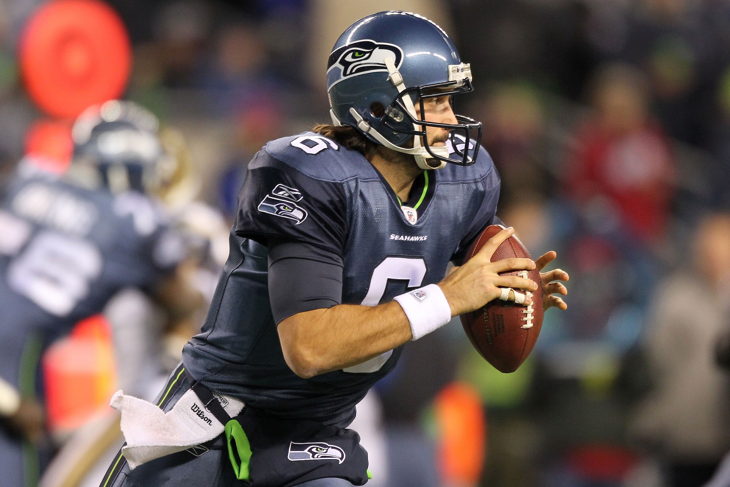 SEATTLE, WA - JANUARY 02:  Quarterback Charlie Whitehurst #6 of the Seattle Seahawks rolls out with the ball during their game against the St. Louis Rams at Qwest Field on January 2, 2011 in Seattle, Washington.  (Photo by Otto Greule Jr/Getty Images)