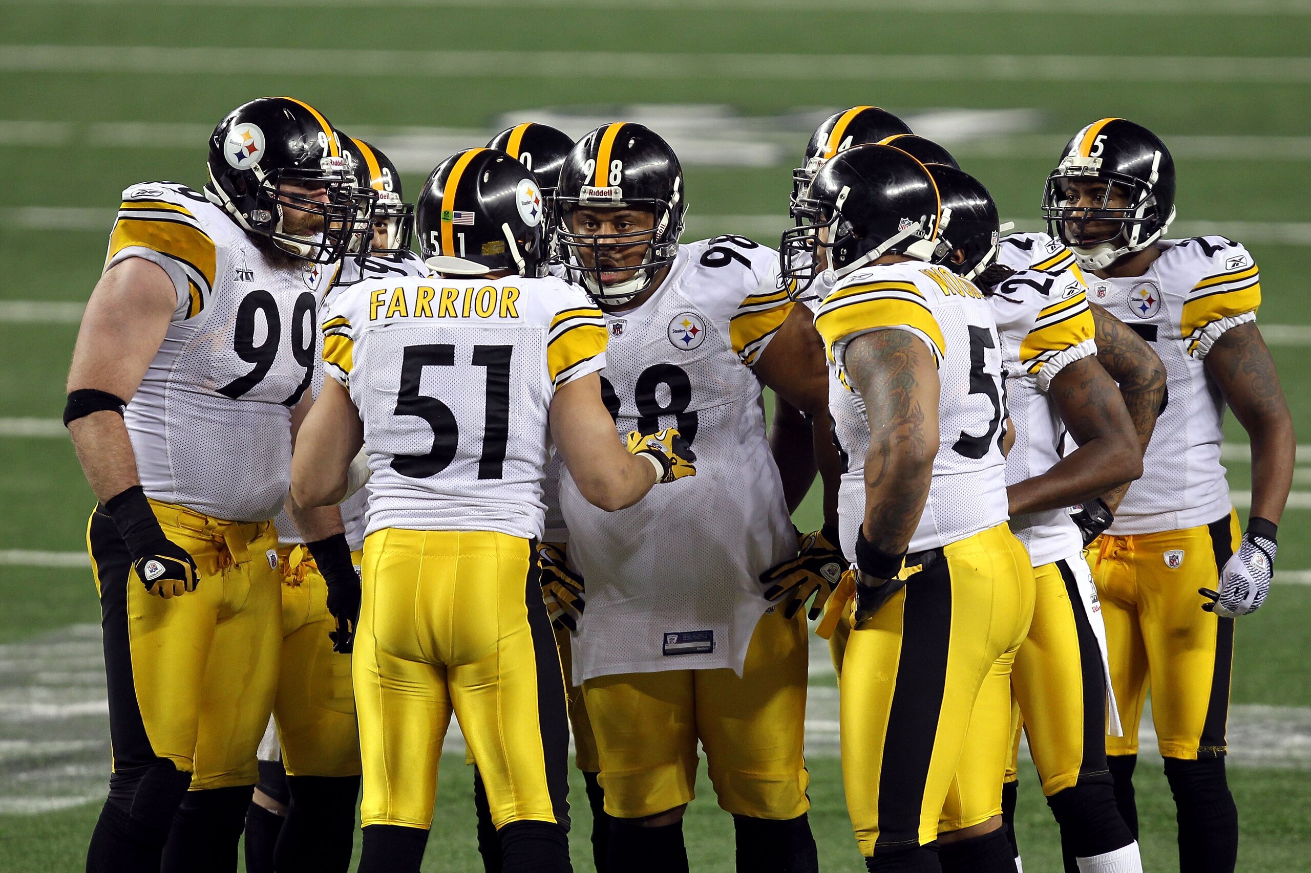 ARLINGTON, TX - FEBRUARY 06:  James Farrior #51 of the Pittsburgh Steelers calls a play in the defensive huddle as Brett Keisel #99 and Casey Hampton #98 (c) look on against the Green Bay Packers during Super Bowl XLV at Cowboys Stadium on February 6, 201