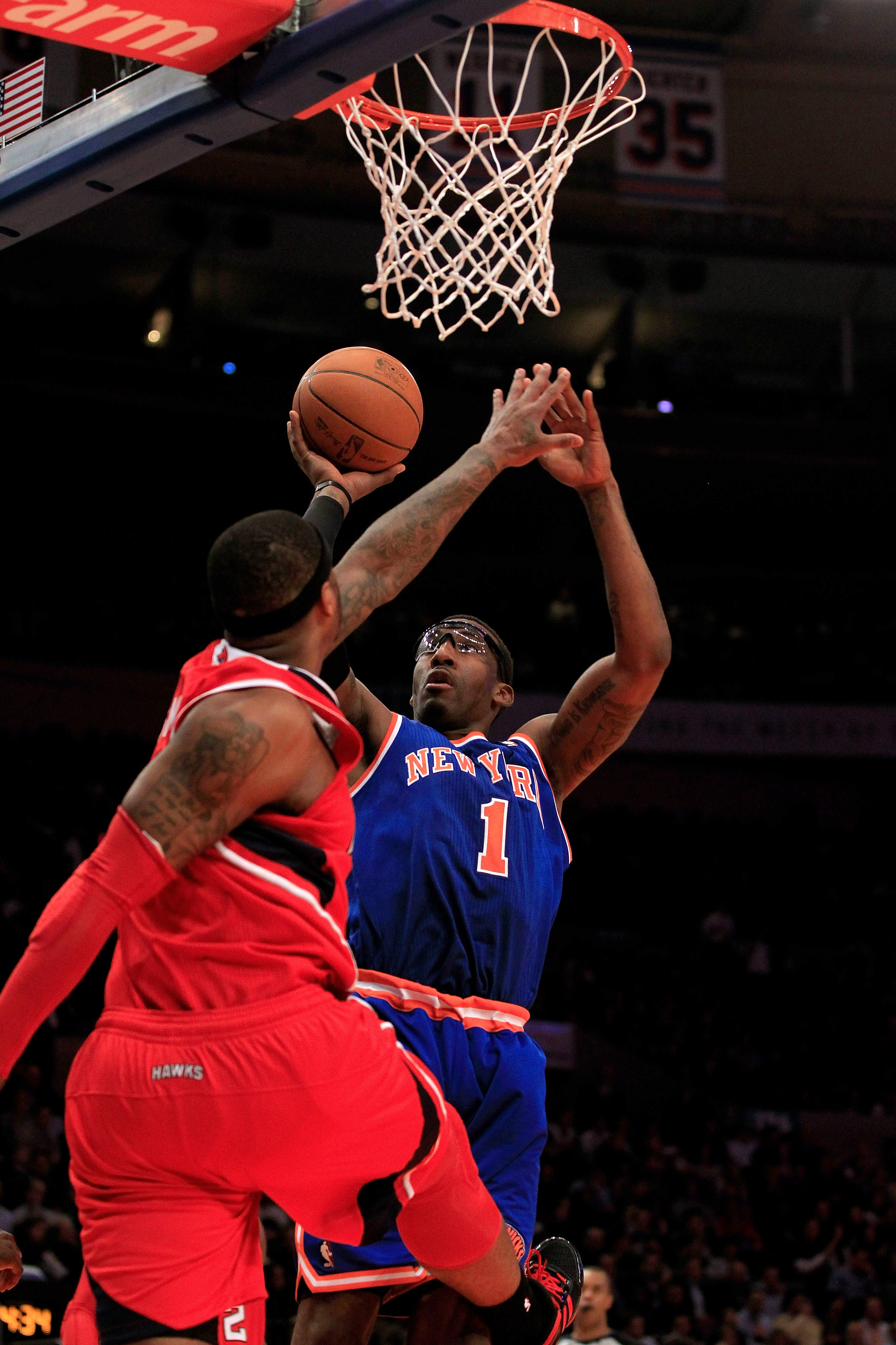 NEW YORK, NY - FEBRUARY 16:  Amar'e Stoudemire #1 of the New York Knicks shoots the ball over Josh Smith #5 of the Atlanta Hawks at Madison Square Garden on February 16, 2011 in New York City. NOTE TO USER: User expressly acknowledges and agrees that, by 