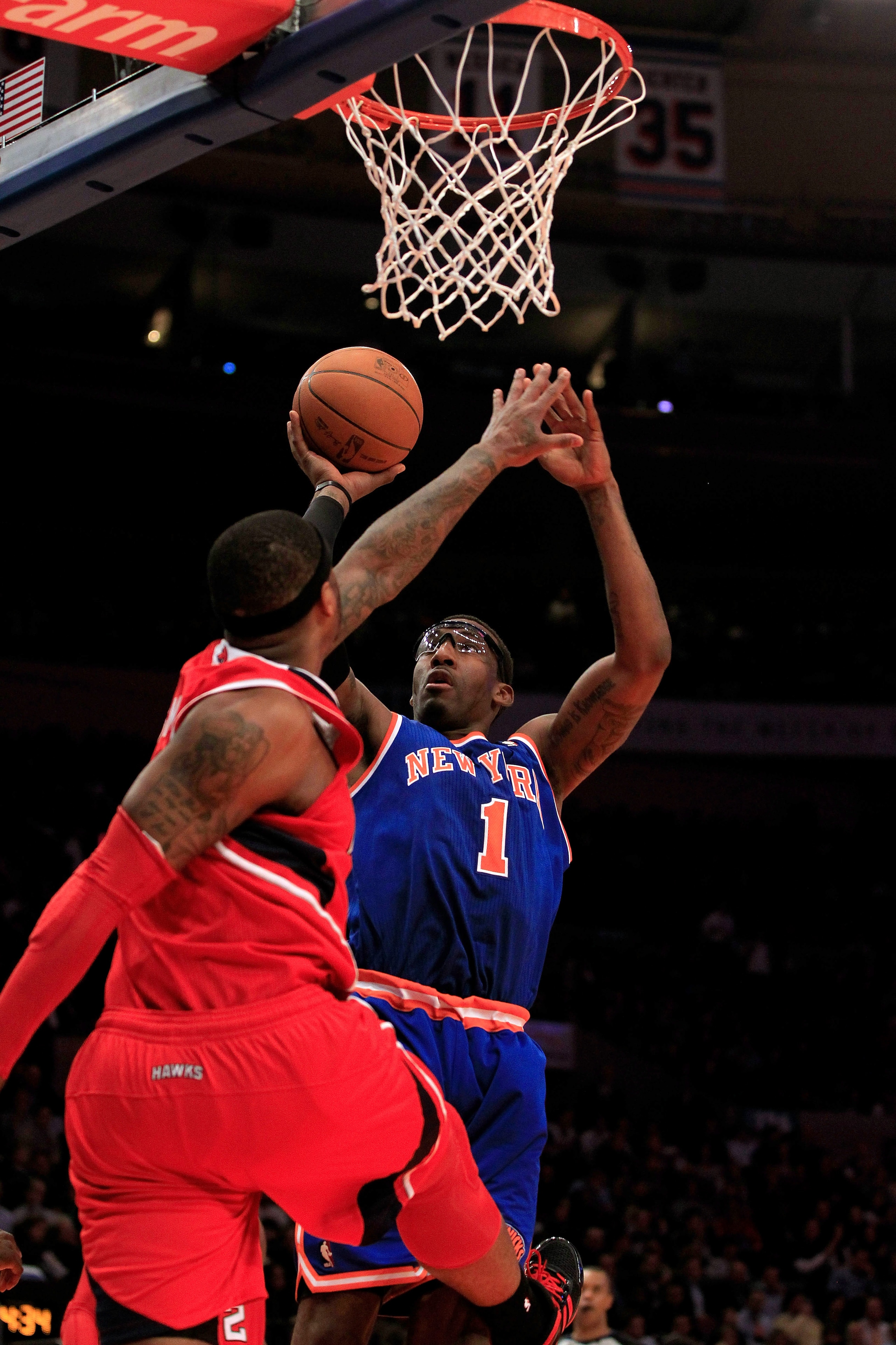 NEW YORK, NY - FEBRUARY 16:  Amar'e Stoudemire #1 of the New York Knicks shoots the ball over Josh Smith #5 of the Atlanta Hawks at Madison Square Garden on February 16, 2011 in New York City. NOTE TO USER: User expressly acknowledges and agrees that, by 