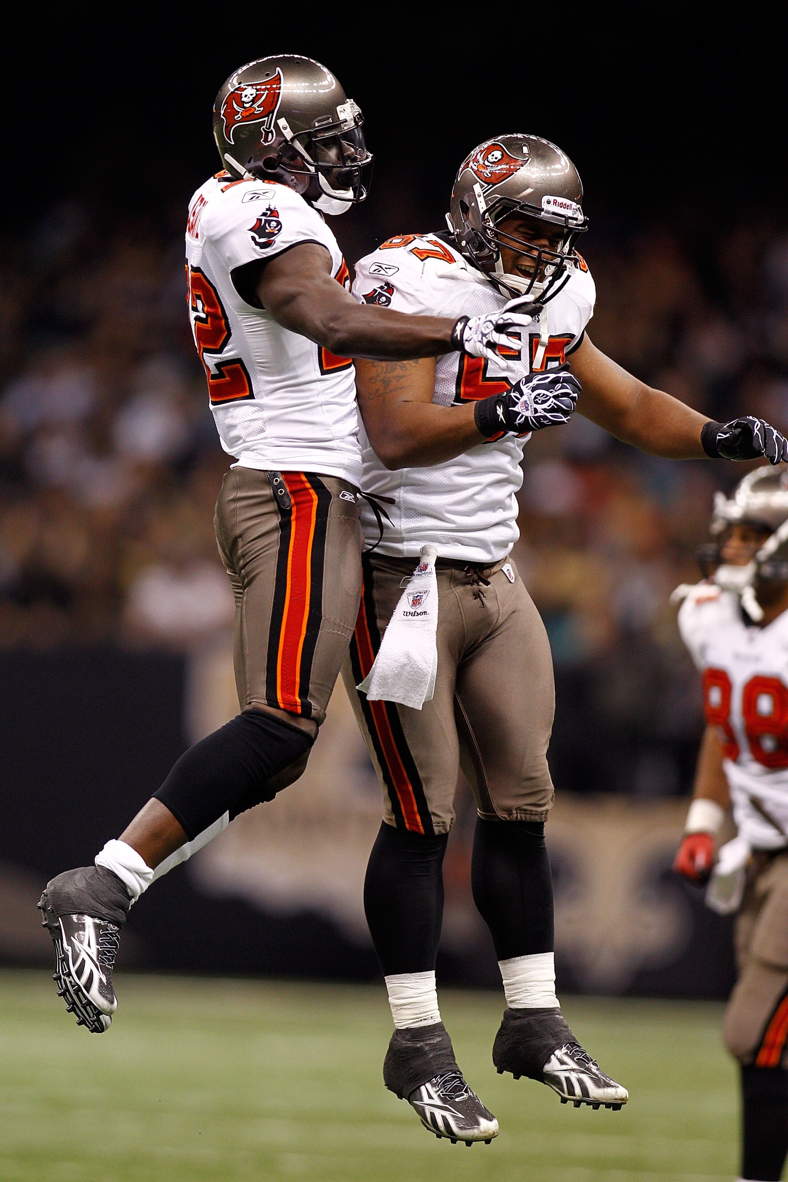 NEW ORLEANS, LA - JANUARY 02:  Larry Asante #22  and Adam Hayward #57 of the Tampa Bay Buccaneers celebrate after Asante intercepted a pass during the game against the New Orleans Saints at the Louisiana Superdome on January 2, 2011 in New Orleans, Louisi