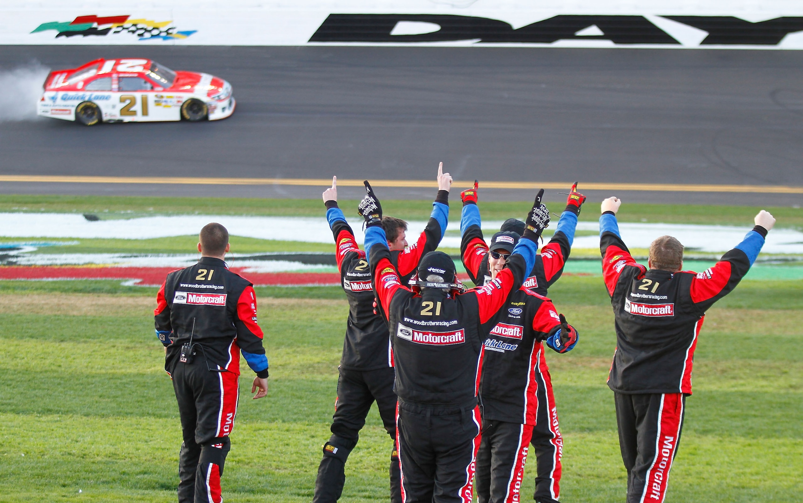 DAYTONA BEACH, FL - FEBRUARY 20: Crew members for Trevor Bayne, driver of the #21 Motorcraft/Quick Lane Ford, celebrate in pit row as Bayne performs a burnout after winning the NASCAR Sprint Cup Series Daytona 500 at Daytona International Speedway on Feb DAYTONA BEACH, FL - FEBRUARY 20: Crew members for Trevor Bayne, driver of the #21 Motorcraft/Quick Lane Ford, celebrate in pit row as Bayne performs a burnout after winning the NASCAR Sprint Cup Series Daytona 500 at Daytona International Speedway on Feb