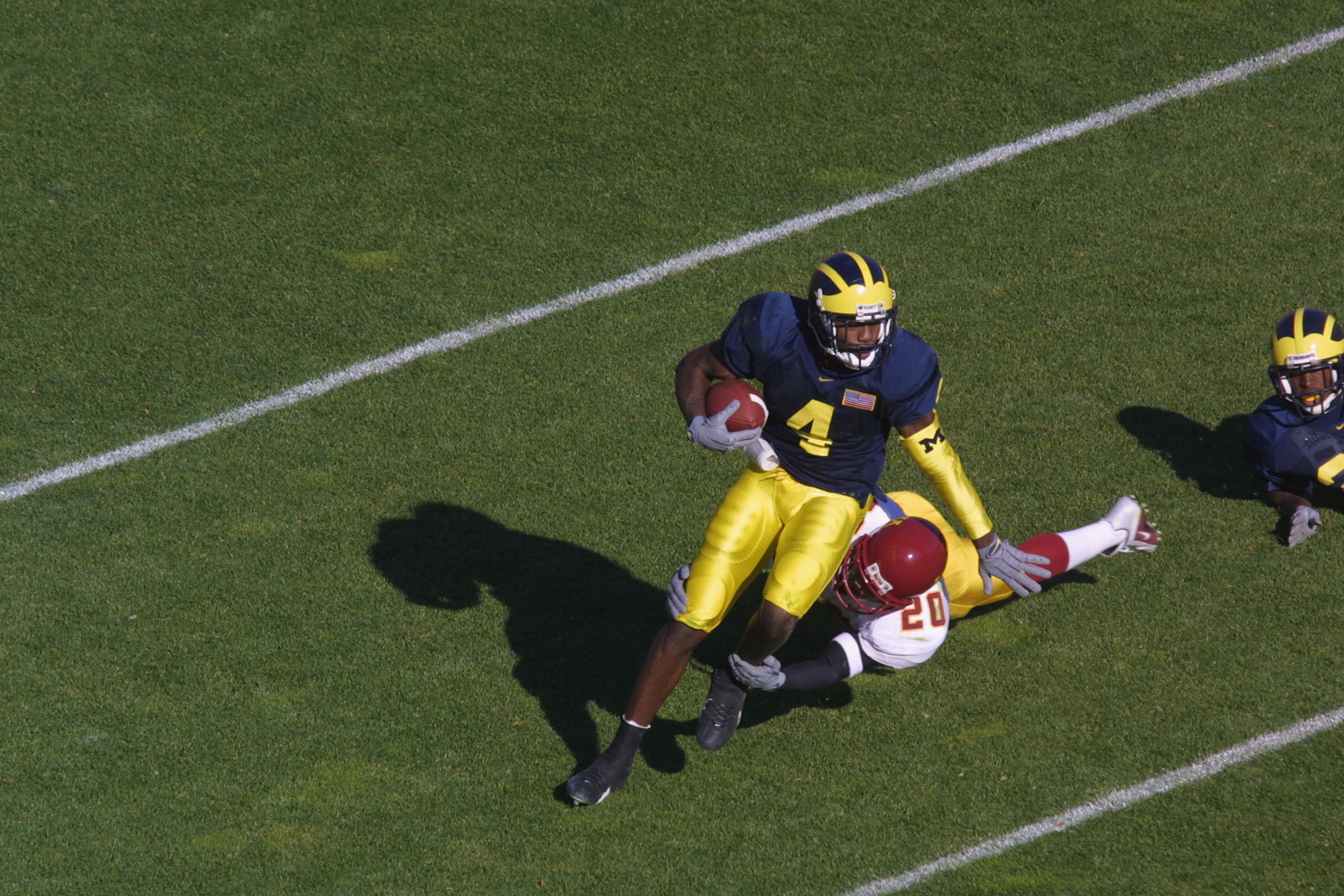 ANN ARBOR, MI - NOVEMBER 10: Cornerback Justin Isom #20 of the Minnesota Golden Gophers hogties wide receiver Marquise Walker #4 of the Michigan Wolverines during the Big Ten Conference football game on November 10, 2001 at Michigan Stadium in Ann Arbor, ANN ARBOR, MI - NOVEMBER 10: Cornerback Justin Isom #20 of the Minnesota Golden Gophers hogties wide receiver Marquise Walker #4 of the Michigan Wolverines during the Big Ten Conference football game on November 10, 2001 at Michigan Stadium in Ann Arbor,