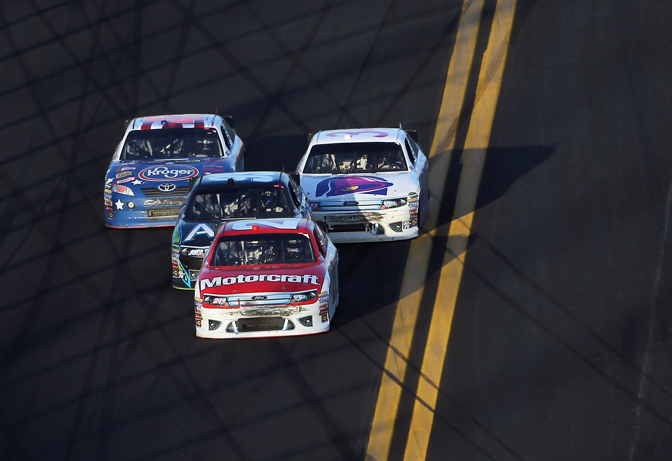 DAYTONA BEACH, FL - FEBRUARY 20: Trevor Bayne, driver of the #21 Motorcraft/Quicklane Ford, leads the final lap as he approaches the finish line on his way toward winning the NASCAR Sprint Cup Series Daytona 500 at Daytona International Speedway on Febru DAYTONA BEACH, FL - FEBRUARY 20: Trevor Bayne, driver of the #21 Motorcraft/Quicklane Ford, leads the final lap as he approaches the finish line on his way toward winning the NASCAR Sprint Cup Series Daytona 500 at Daytona International Speedway on Febru