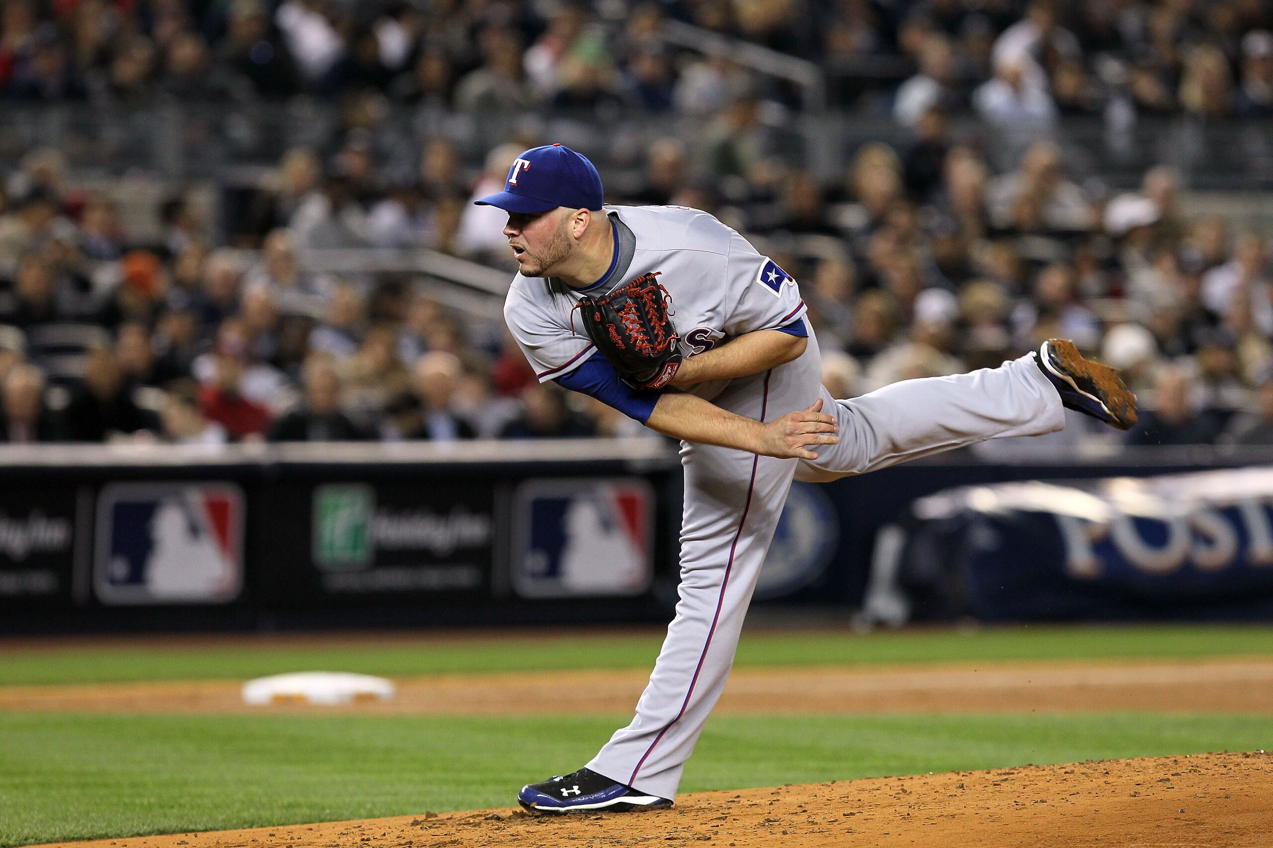 NEW YORK - OCTOBER 19:  Tommy Hunter #35 of the Texas Rangers pitches against the New York Yankees in Game Four of the ALCS during the 2010 MLB Playoffs at Yankee Stadium on October 19, 2010 in the Bronx borough of New York City. The Rangers won 10-3.  (P